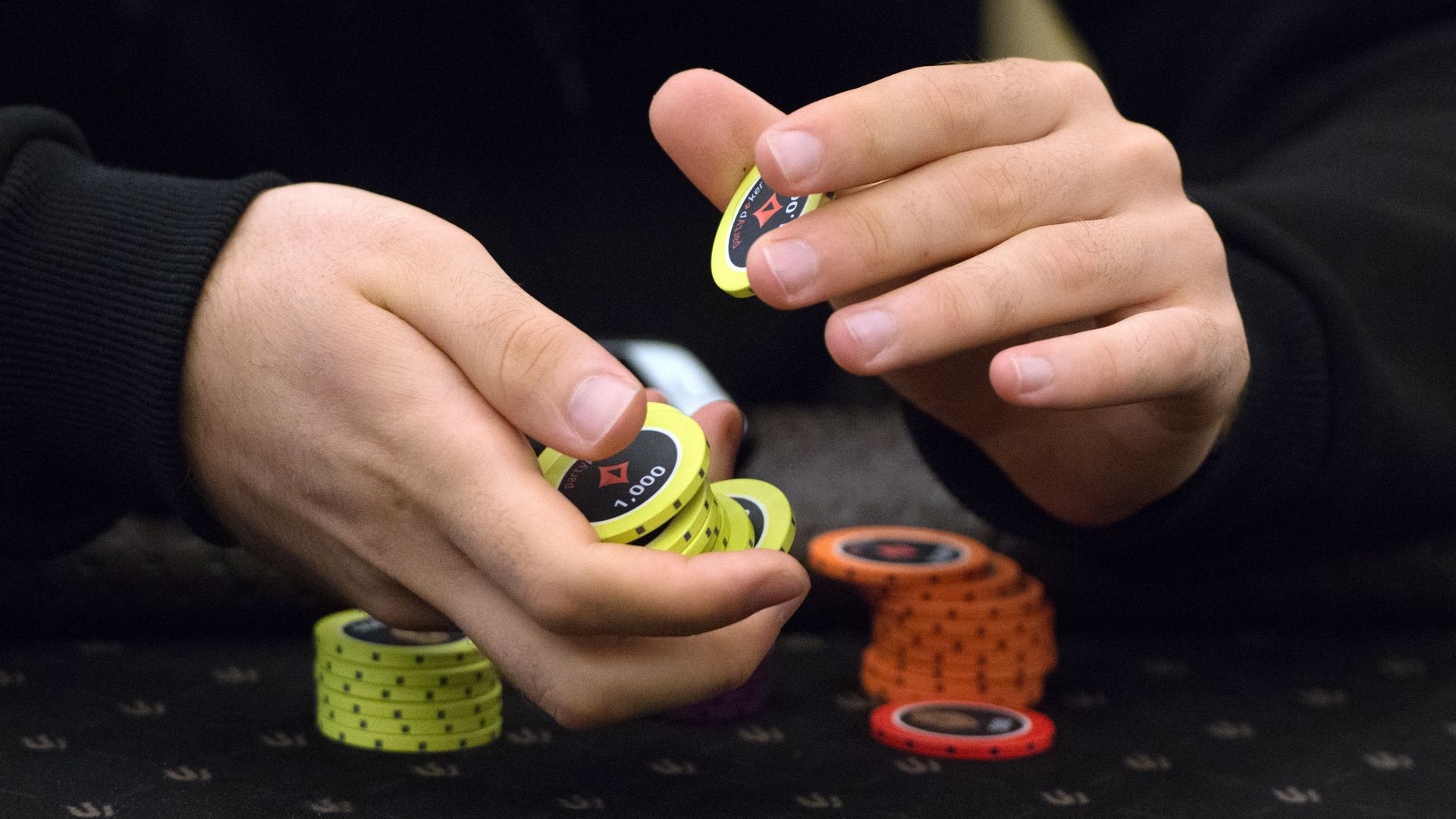 A person holding poker chips.