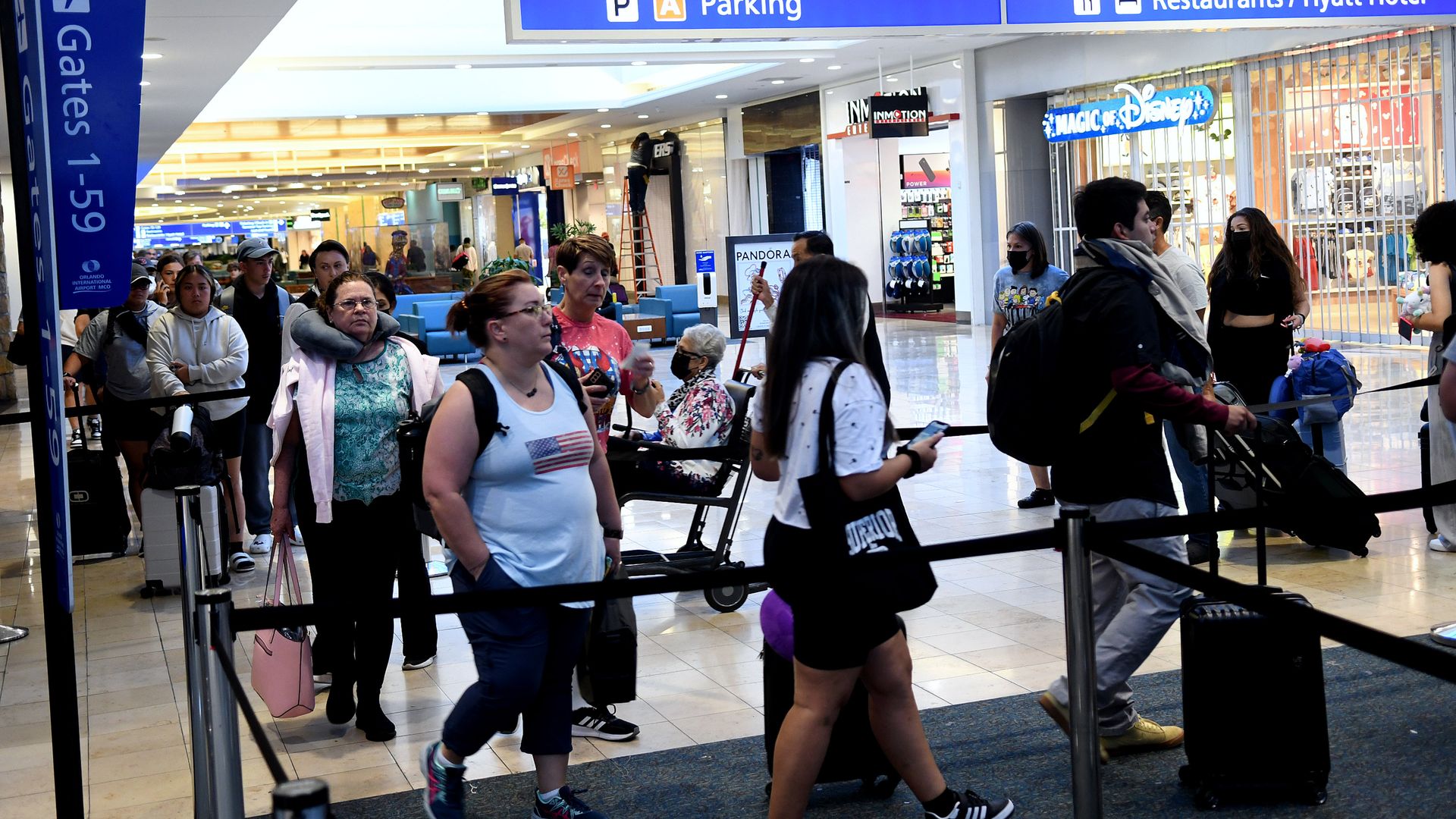 Travelers make their way through a TSA screening line.