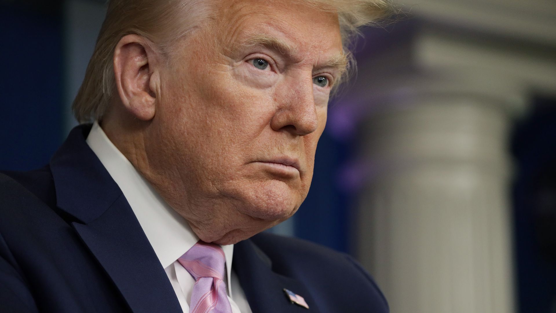 In this image, Trump stands in the briefing room