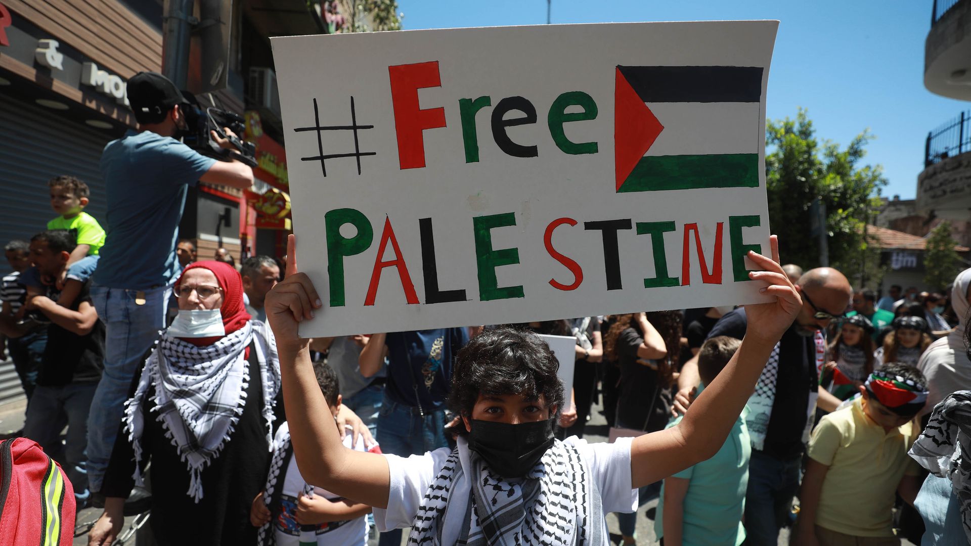 Palestinians gather to stage a protest ongoing Israeli attacks on Gaza Strip and violations in East Jerusalem, on May 18, 2021, in Ramallah,