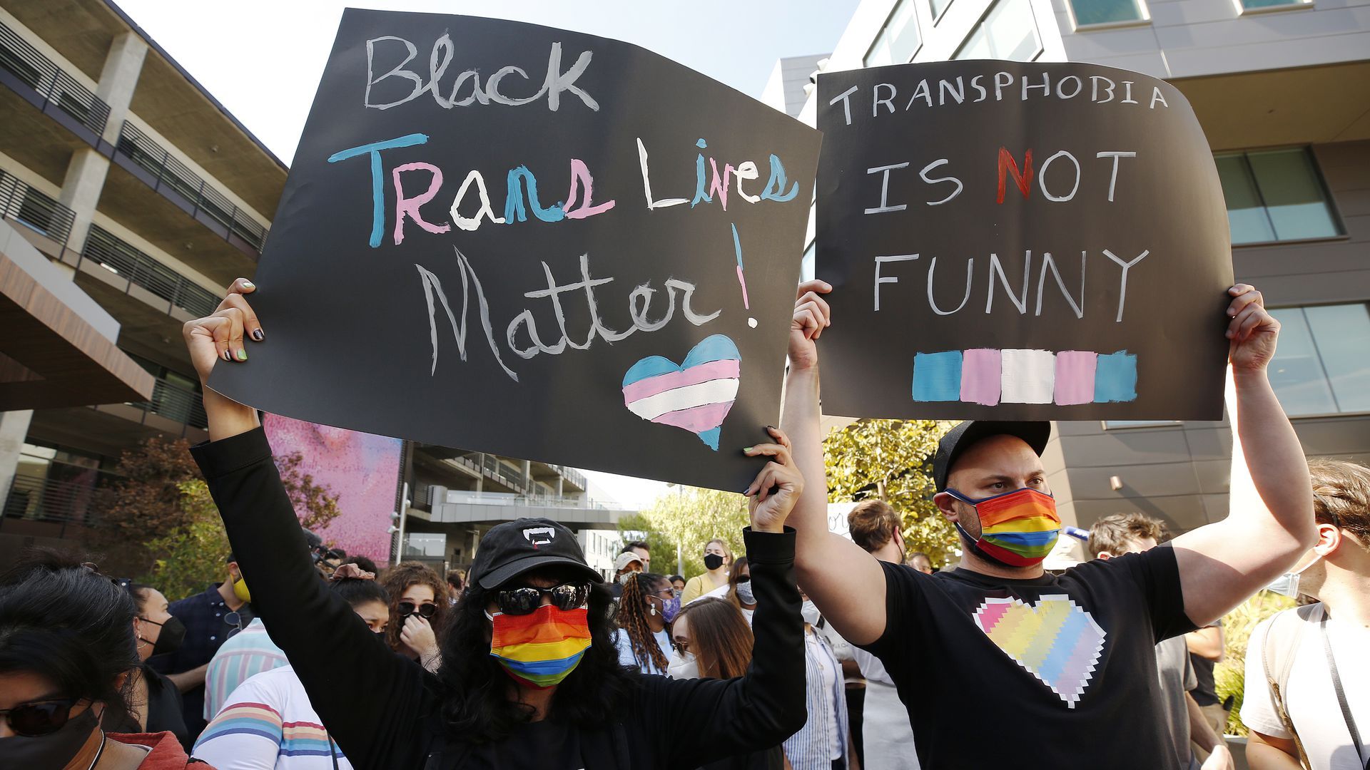 Photo of protesters holding signs outside Netflix offices in Los Angeles