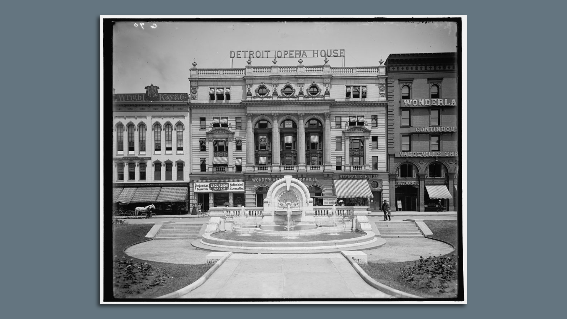 A historic photo of the fountain in front of the old opera house.