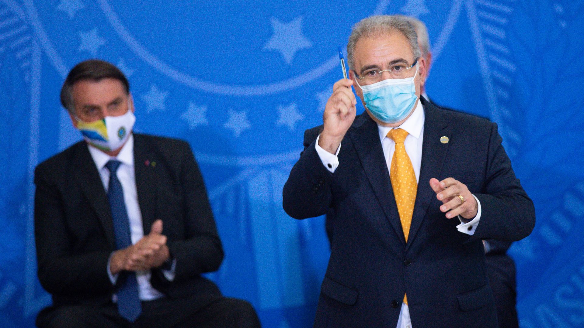 President of Brazil Jair Bolsonaro (L) applauds Health Minister Marcelo Queiroga ( in Brasilia, Brazil, in May. Photo by Andressa Anholete/Getty Images