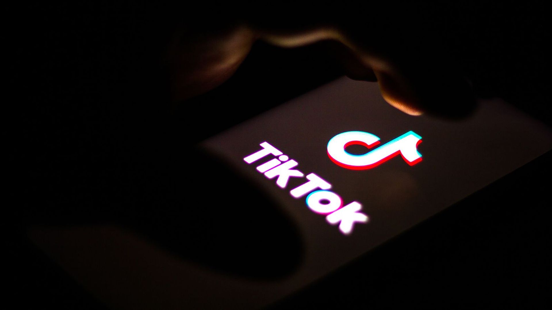 A photo of a TikTok logo on a smartphone