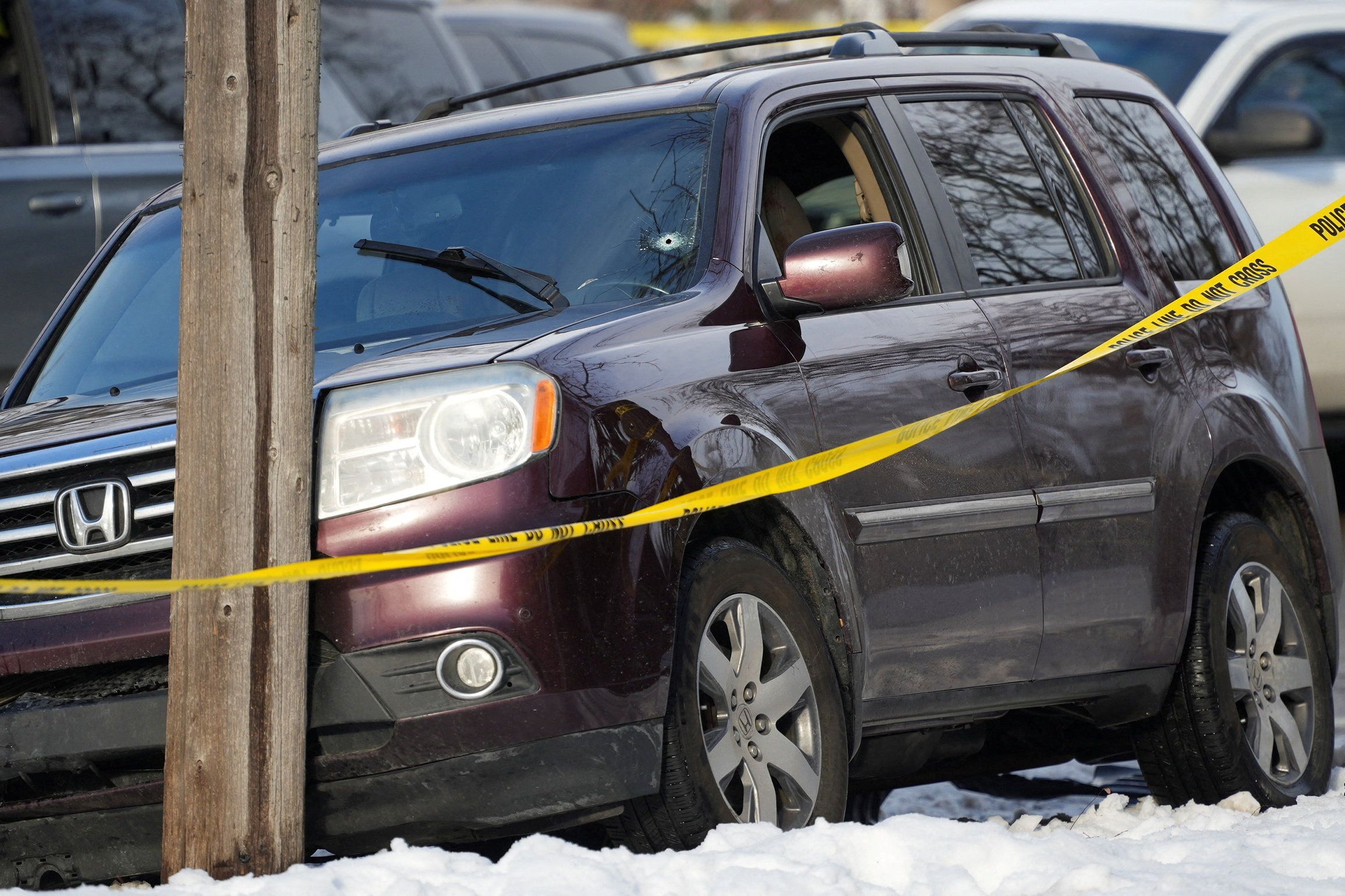 Police tape surrounds a vehicle after an ICE agent shot and killed the driver in Minneapolis yesterday.
