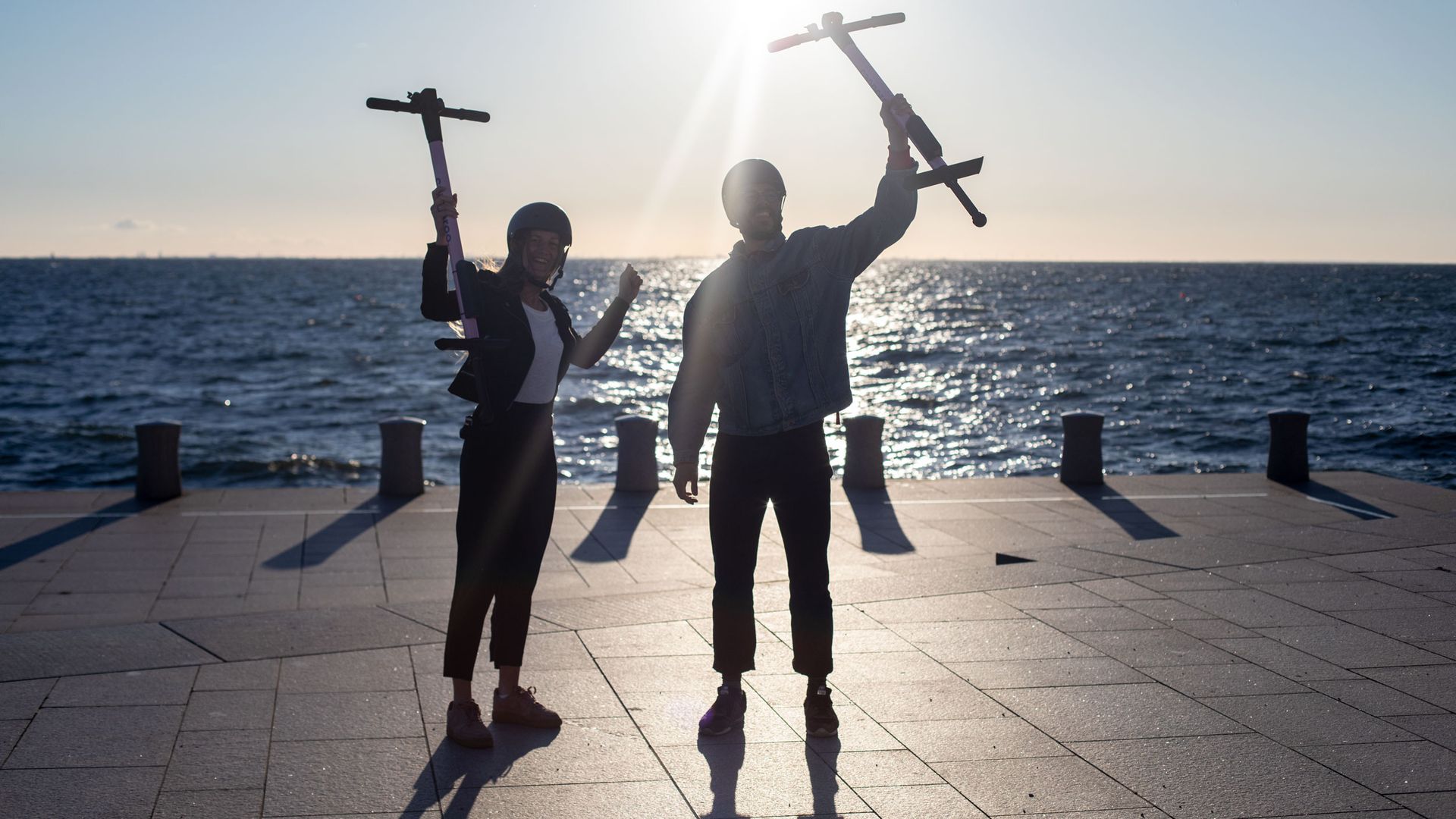 A couple holding pogo sticks