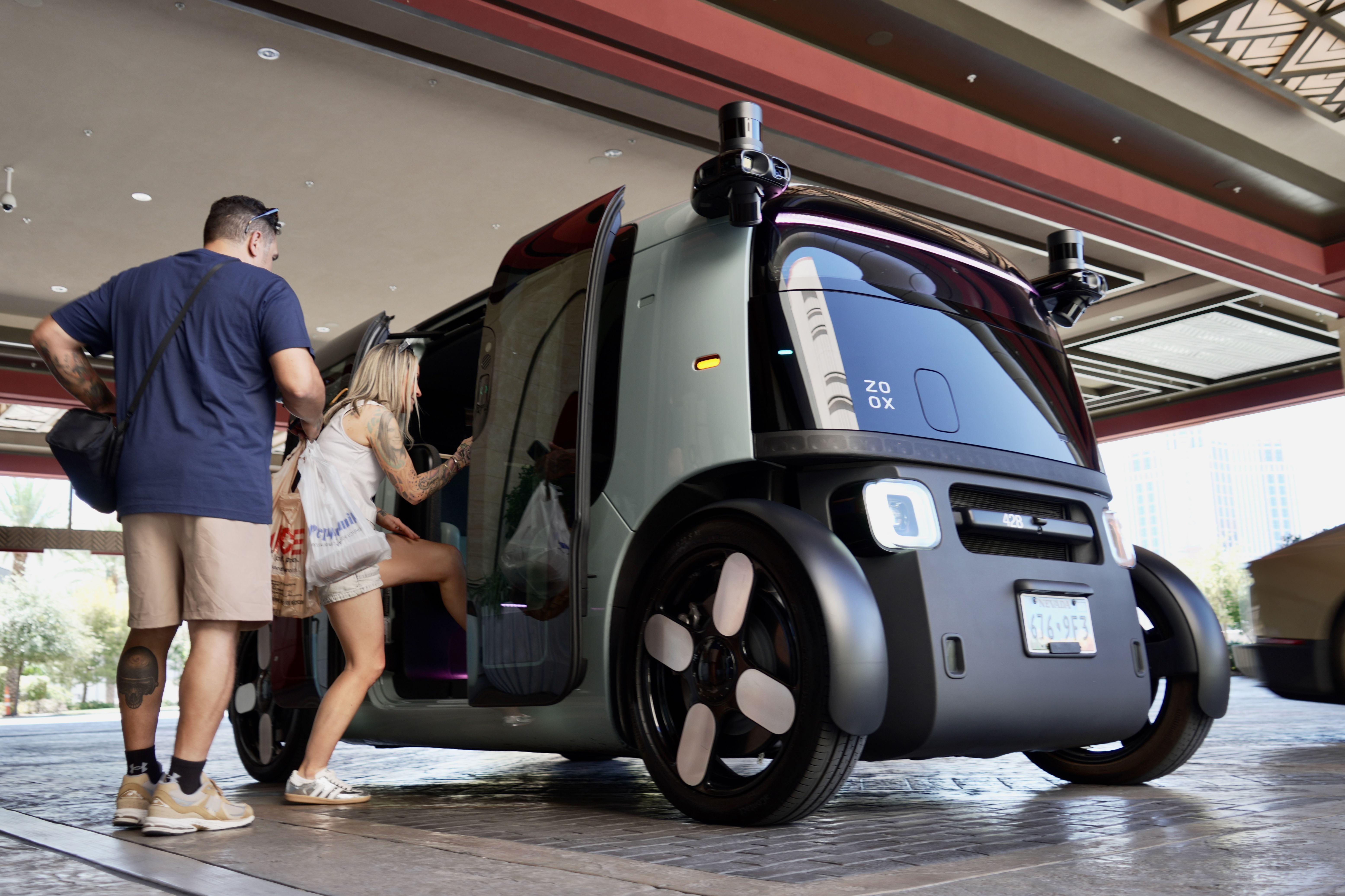Passengers load into a Zoox robotaxi in Las Vegas yesterday. AP Photo/Ty ONeil