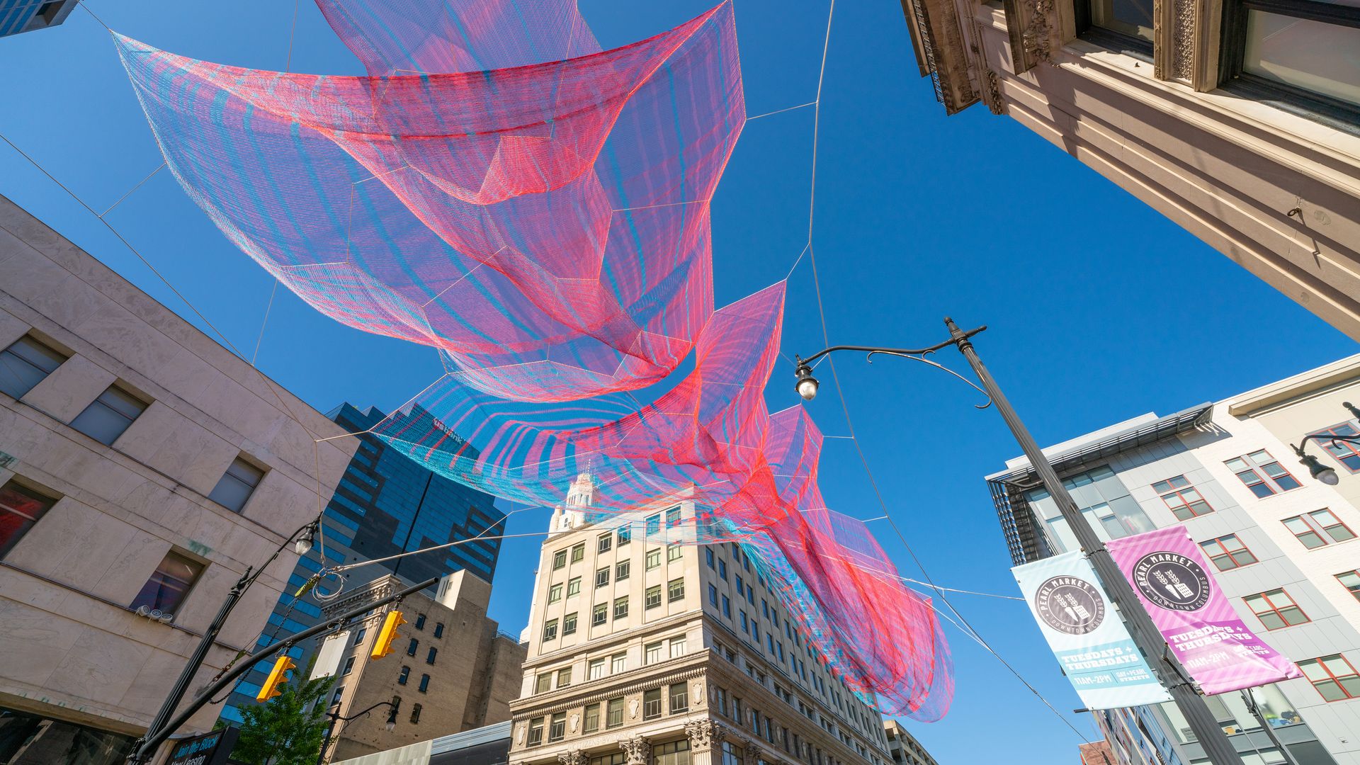 The red and blue "Current" sculpture, made of twine, hangs across the intersection of High and Gay streets