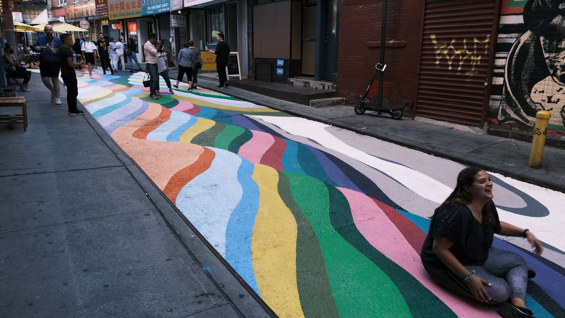 A street in NYC's Chinatown that has been closed to traffic and painted by an artist.
