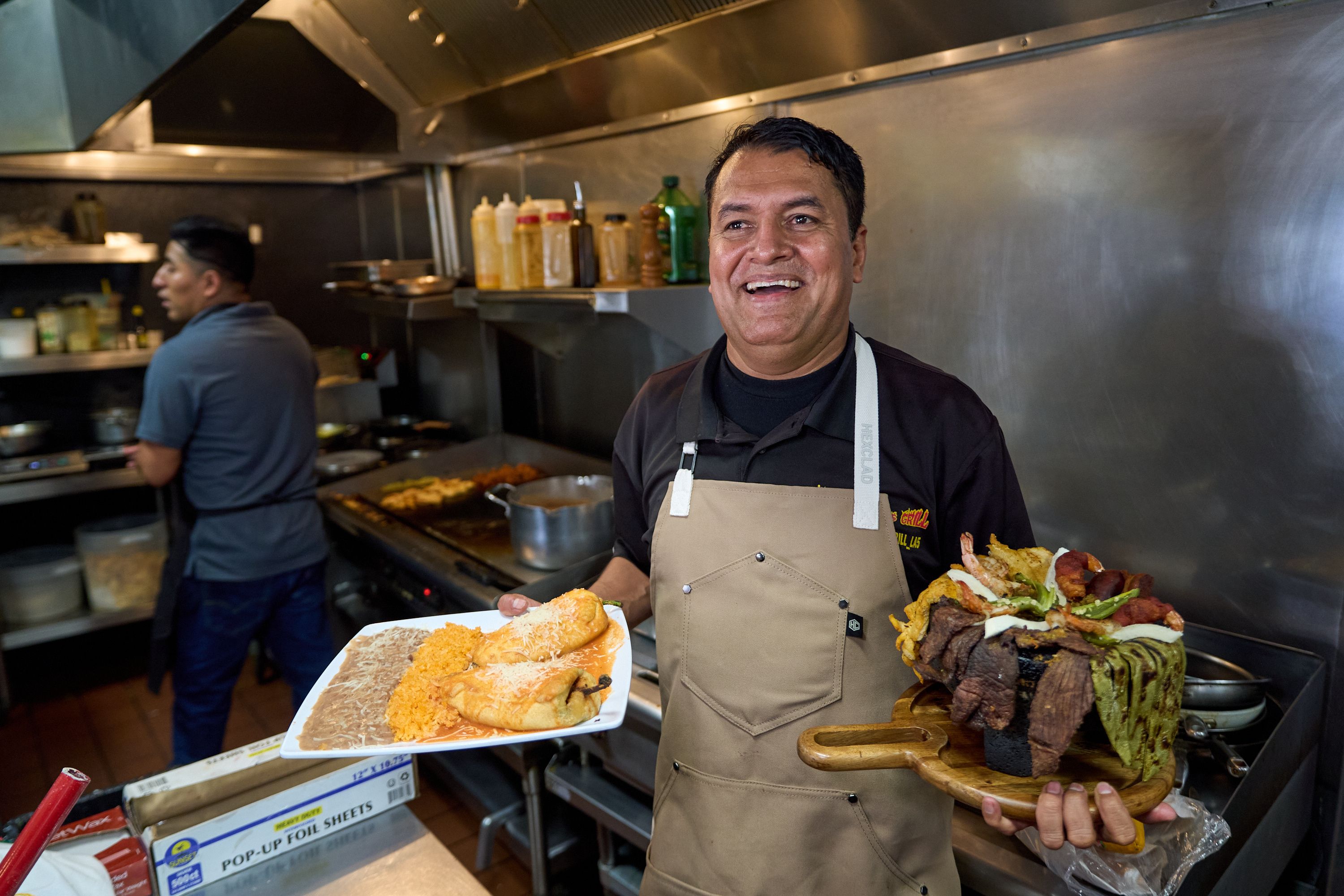 Owner-chef Marco Mendoza prepares a hot molcajete, a traditional Mexican dish, at Cuernavaca's Grill in downtown L.A. Photo: Damian Dovarganes/AP