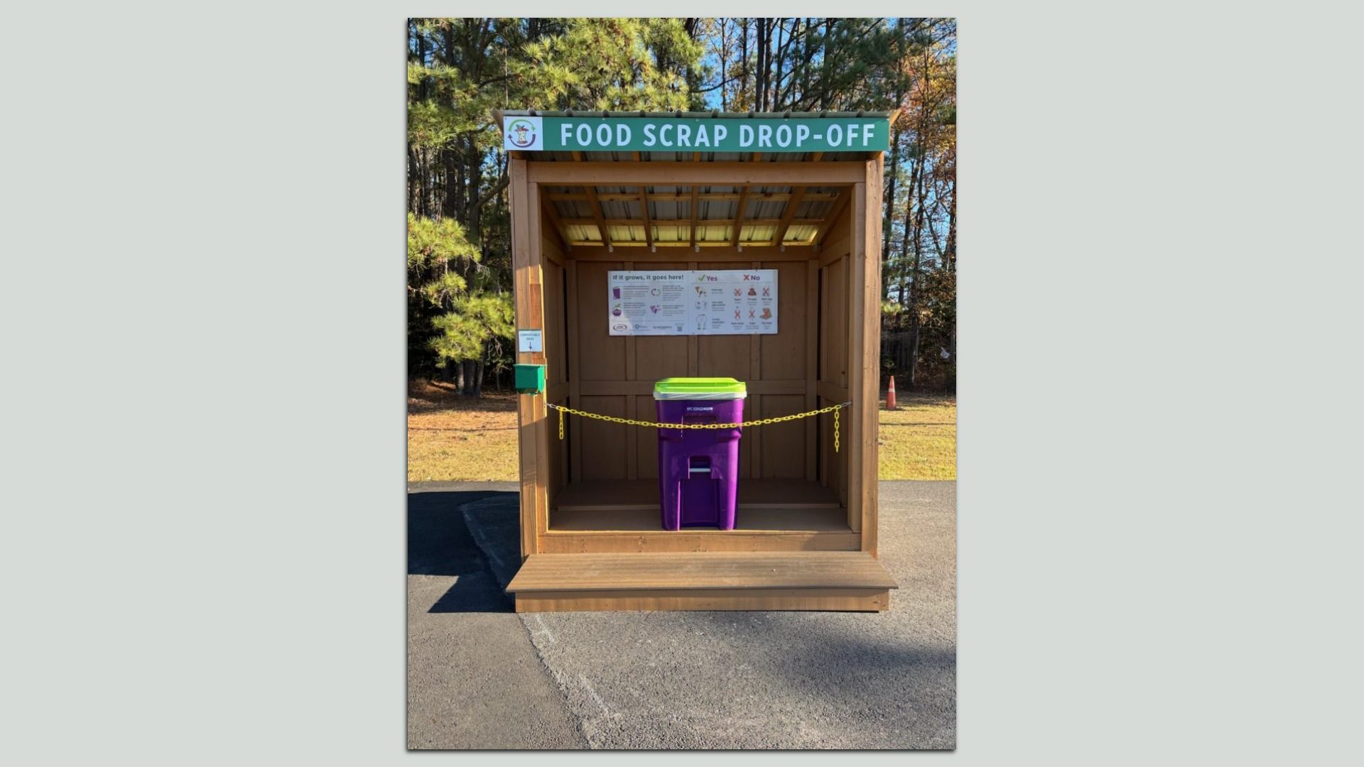 A purple trash bin on a pedestal that says food scrap drop-off 