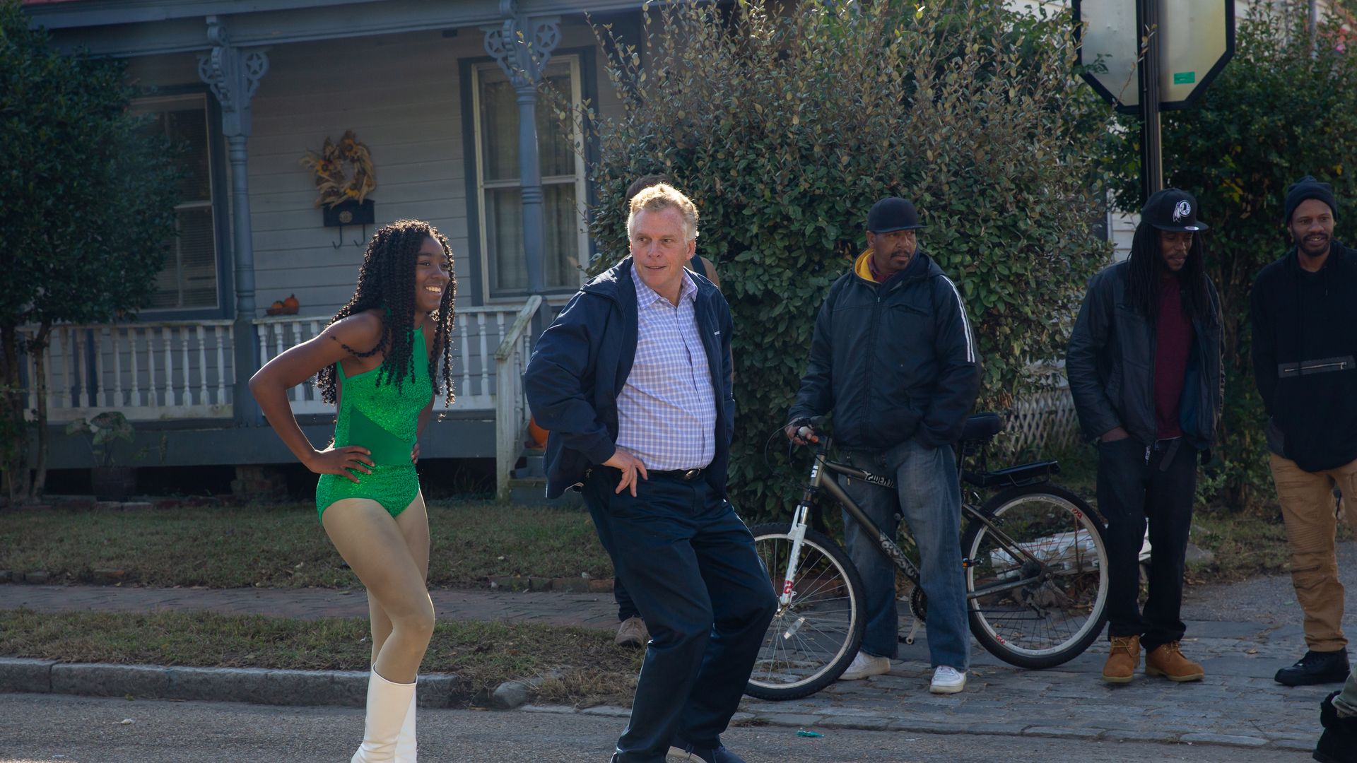 PETERSBURG, VA - OCTOBER 19: Former Gov. Terry McAuliffe of Virginia attempts to join in on a dance group performance during Virginia State University homecoming parade in Petersburg, Va.