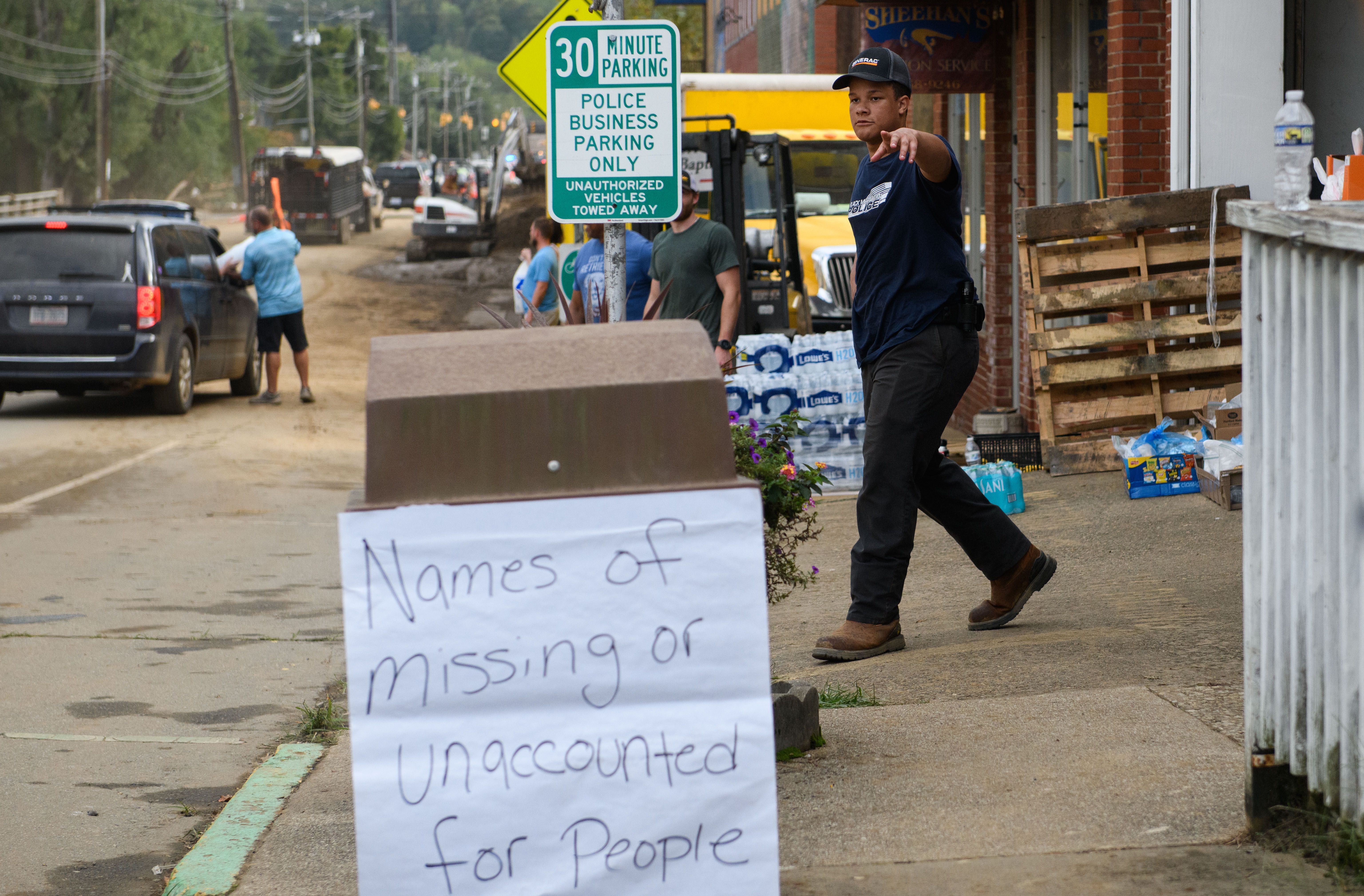 Elijah King directs traffic at a food distribution center at the Town Hall on Catawba Avenue in the aftermath of Hurricane Helene on September 30, 2024 in Old Fort, North Carolina.