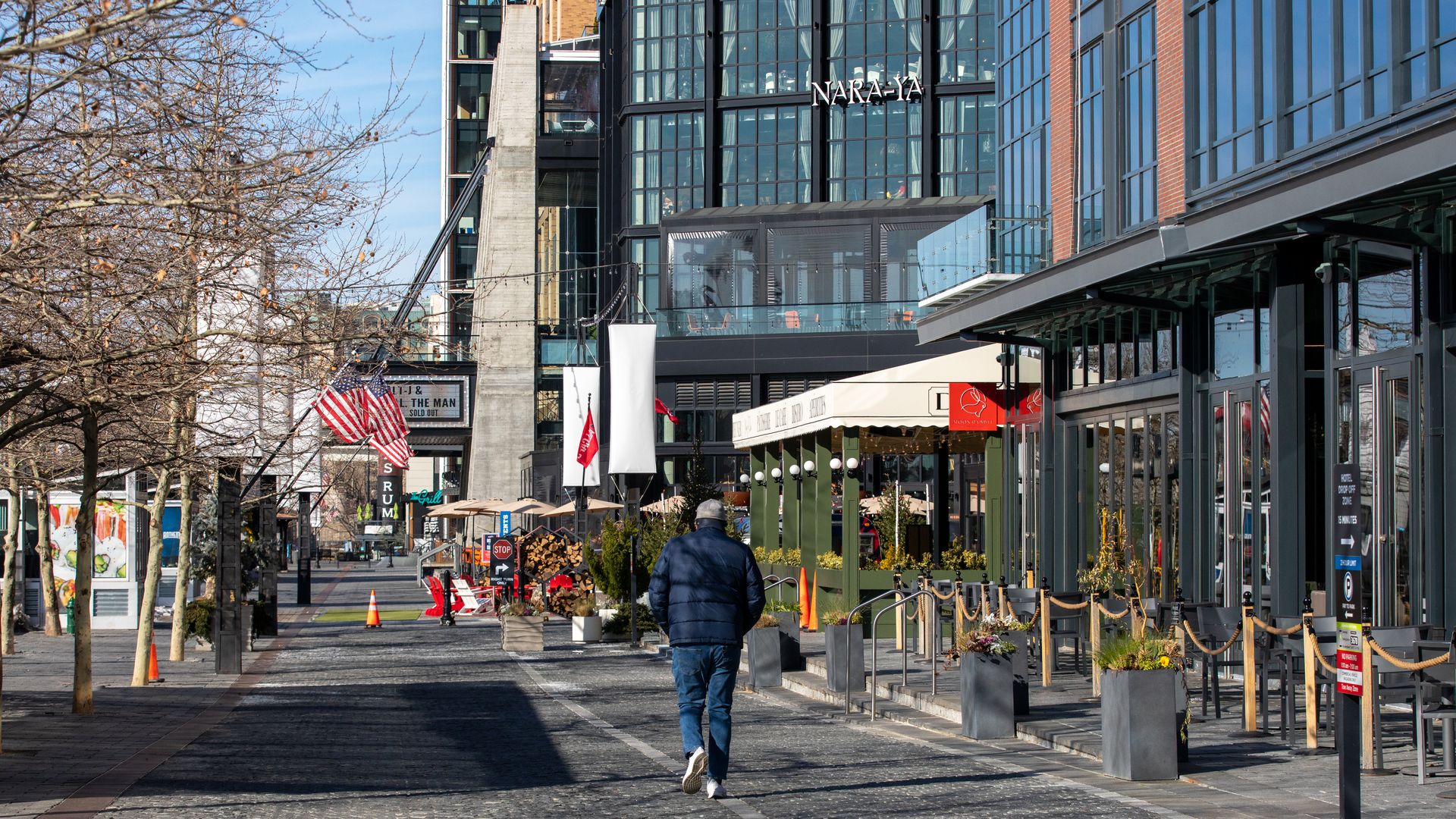 A man walks along the Wharf neighborhood in Washington, D.C.
