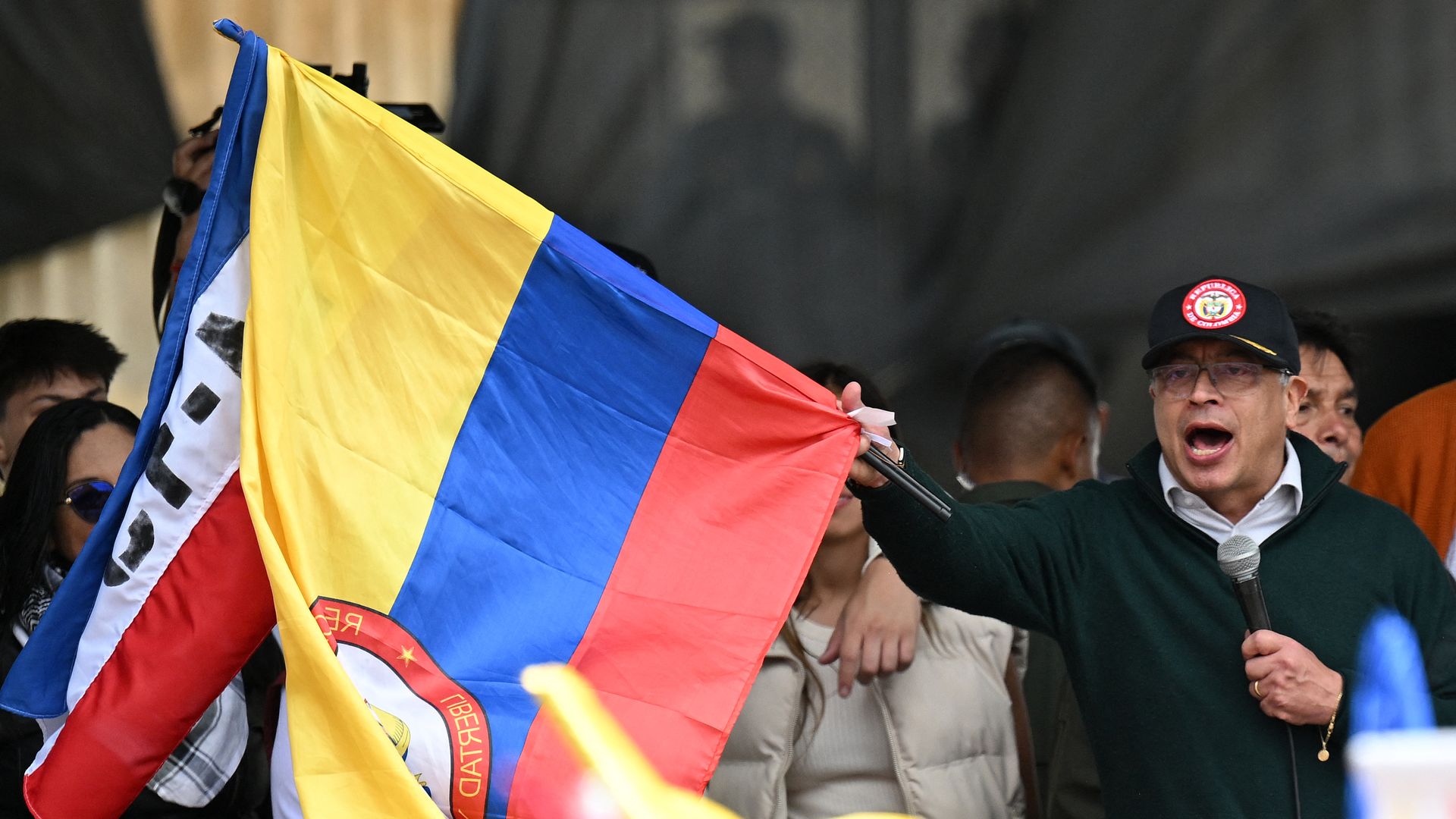  Colombian President Gustavo Petro waves a national flag as he delivers a speech during a May Day (Labor Day) rally in Bogota on May 1, 2024. 