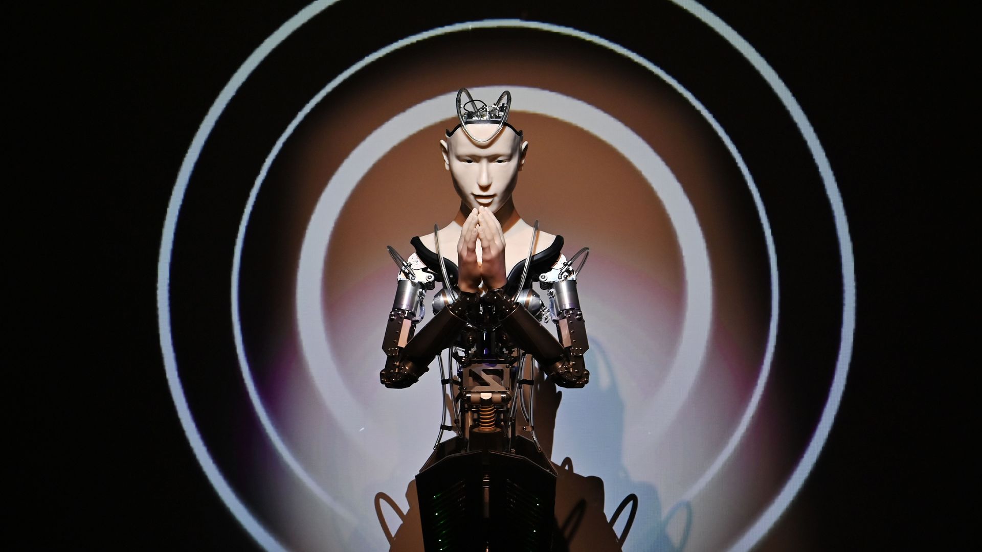 A humanoid robot with its hands folded in prayer