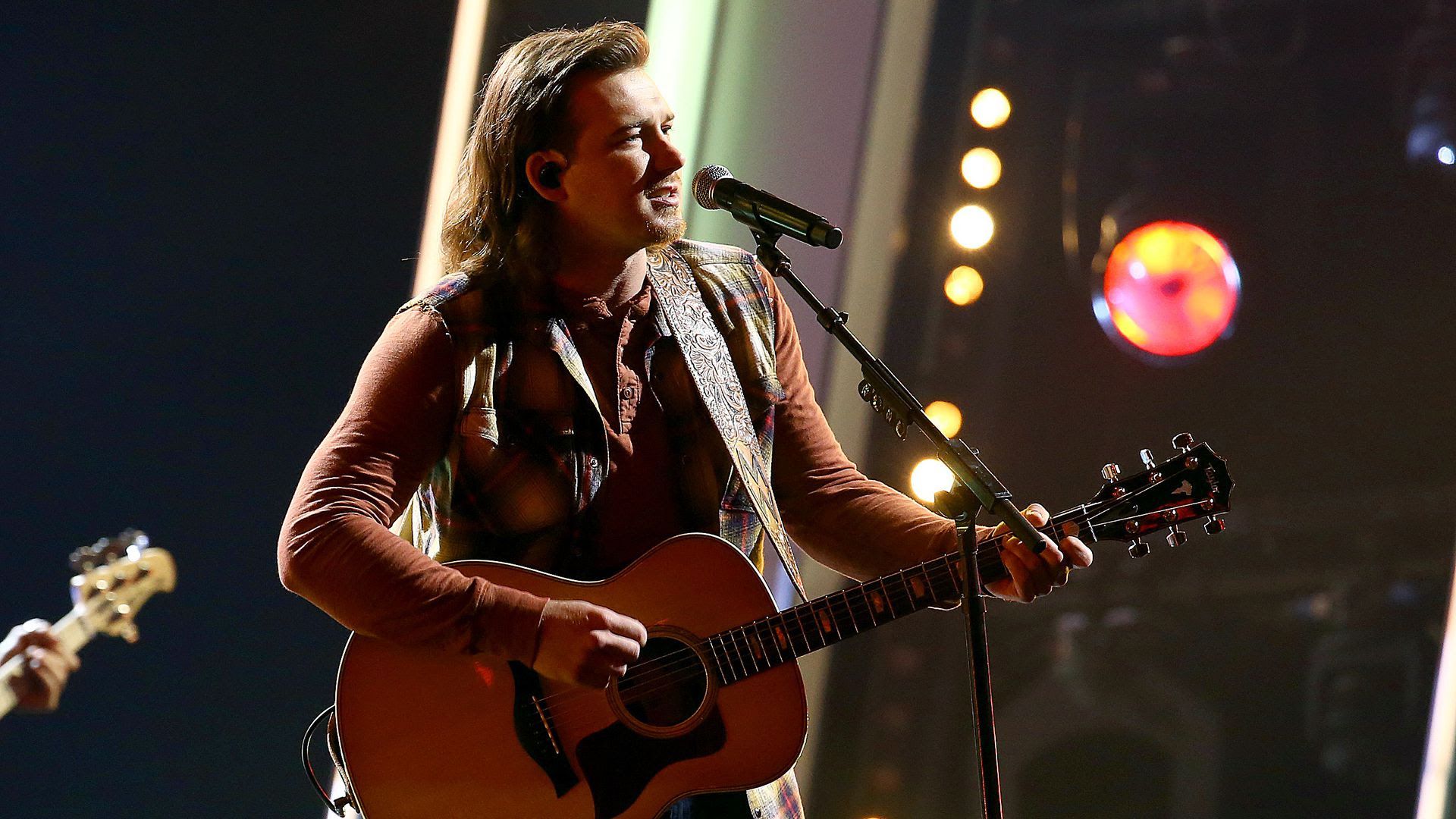 Morgan Wallen performing in 2020 with a guitar.