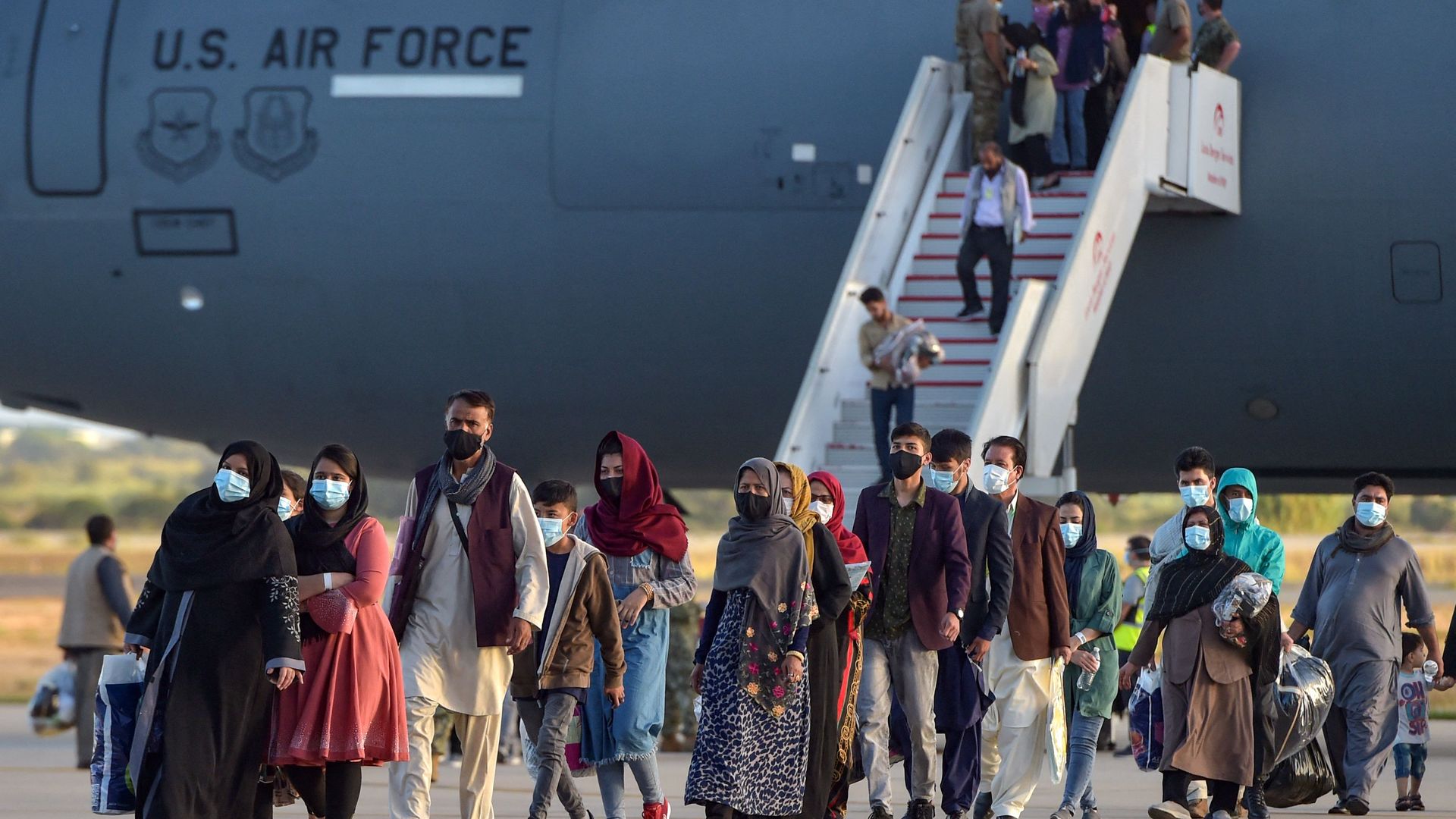 Refugees disembark from a US air force aircraft after an evacuation flight from Kabul at the Rota naval base in Rota, southern Spain, on August 31, 2021.