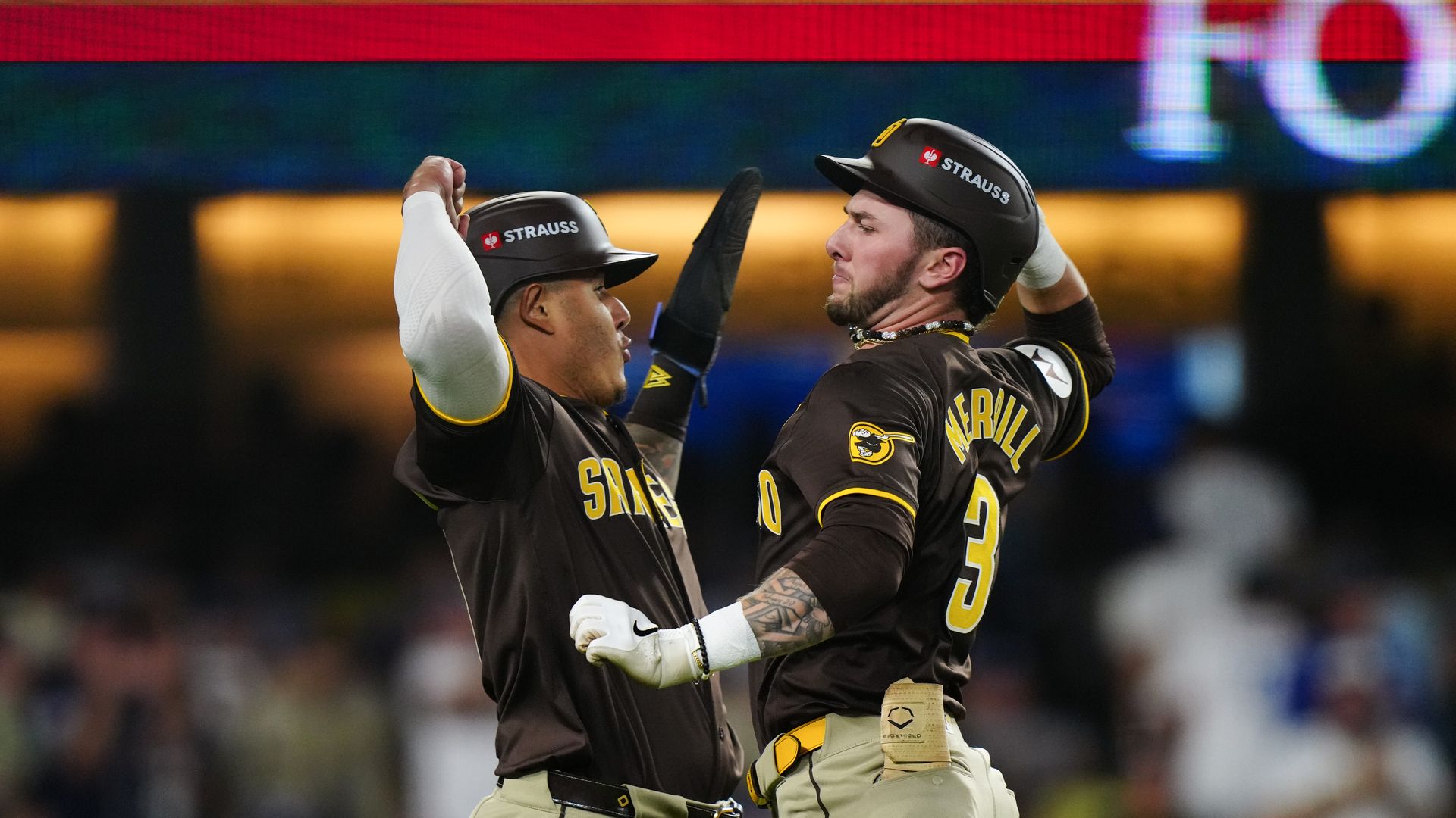 Manny Machado and Jackson Merrill celebrate.
