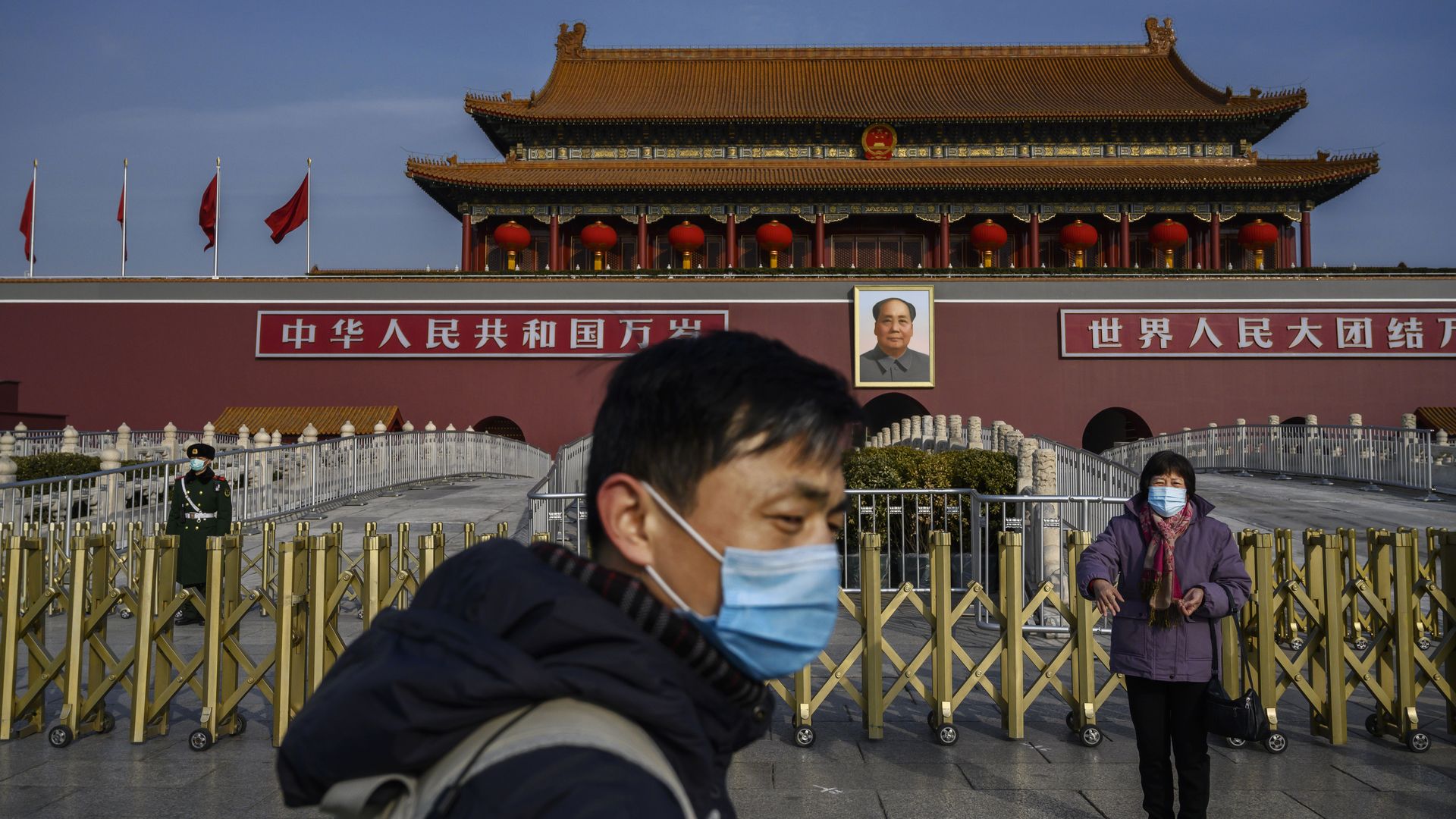 A Chinese couple wear masks as they visit the Tiananmen Gate