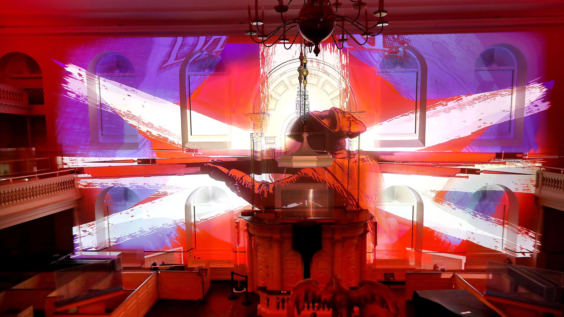 A British redcoat firing during the Boston Massacre is projected on the wall during a new immersive experience about Boston during the American Revolution called "Ruckus" at the Old South Meeting House on June 26, 2026.