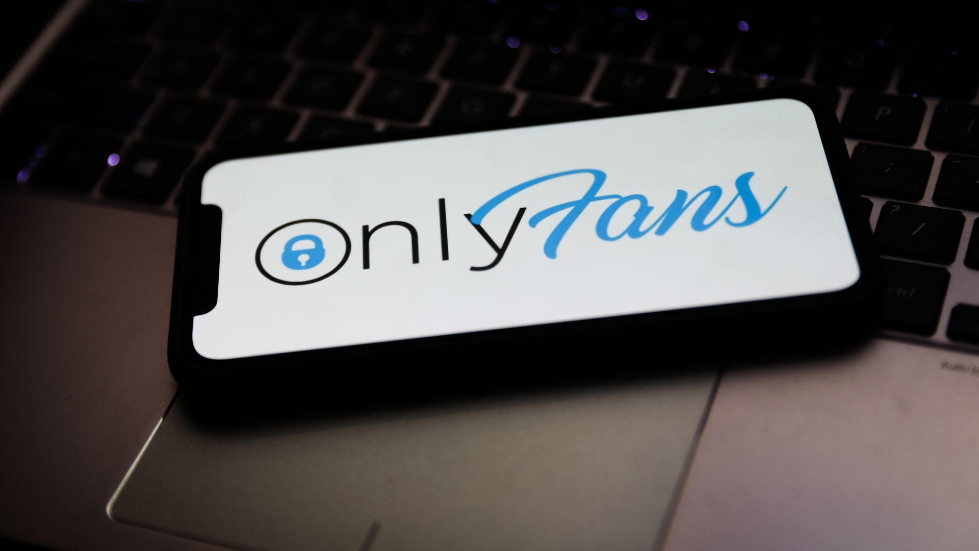 The OnlyFans logo displayed on a phone screen. 