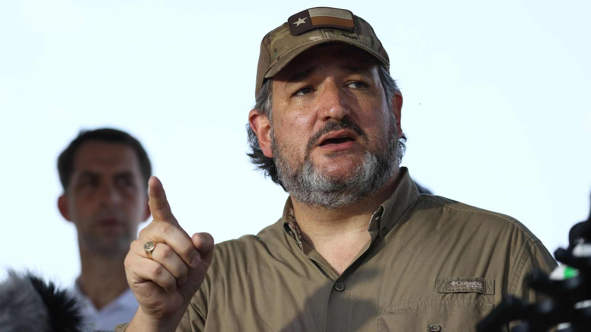 Ted Cruz speaks while wearing a hat