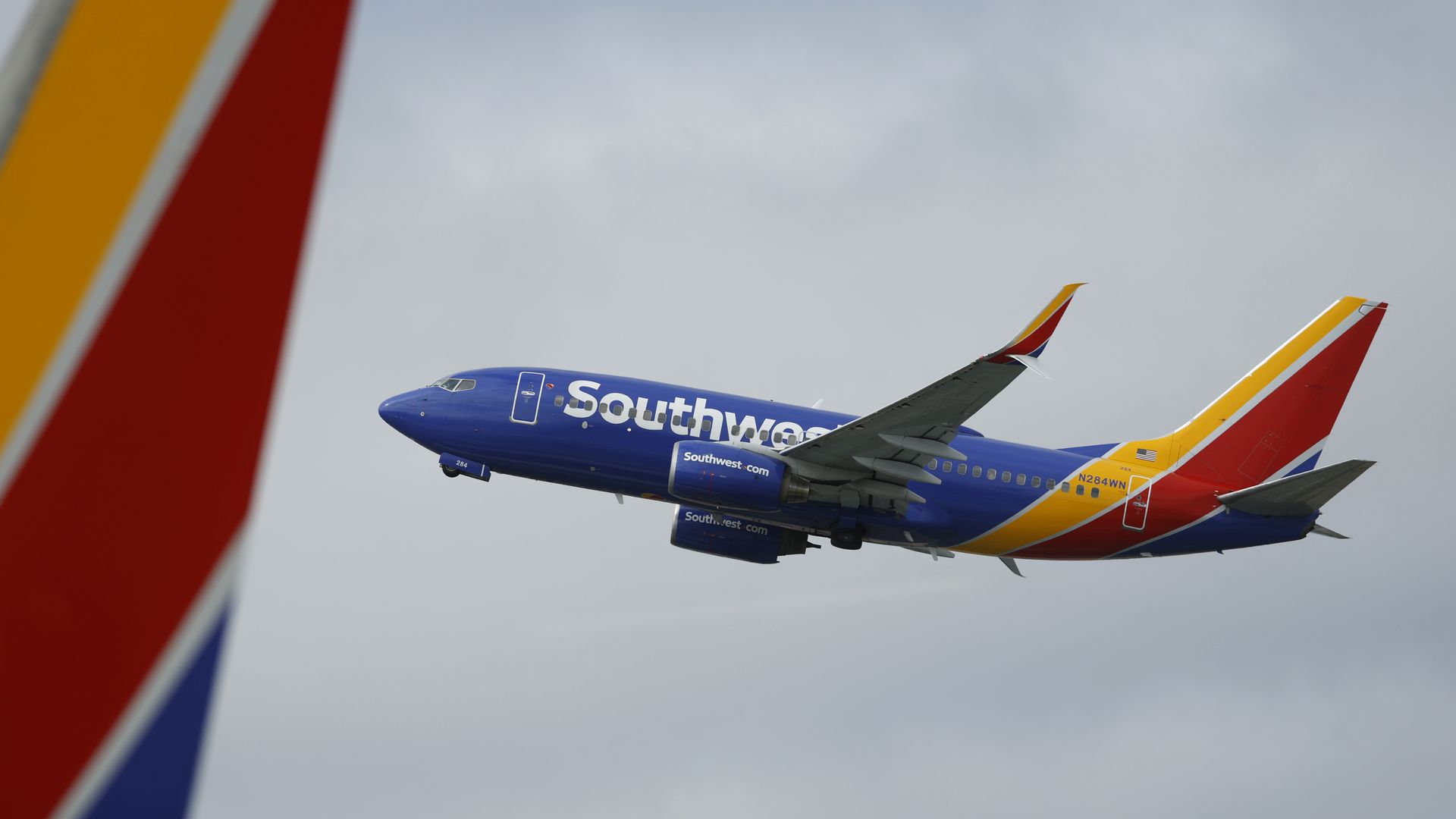A Southwest airplane taking off, flying in the sky