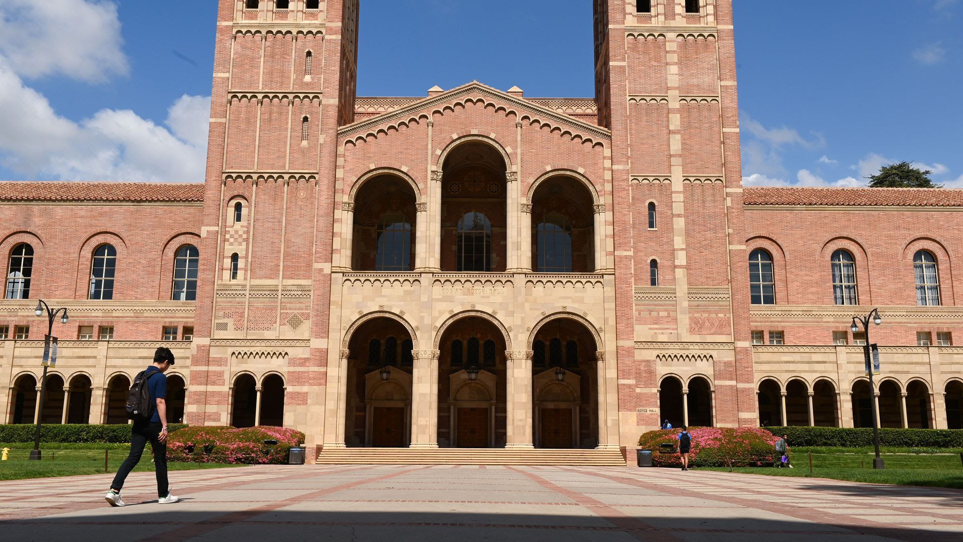 A single student walks on the UCLA campus