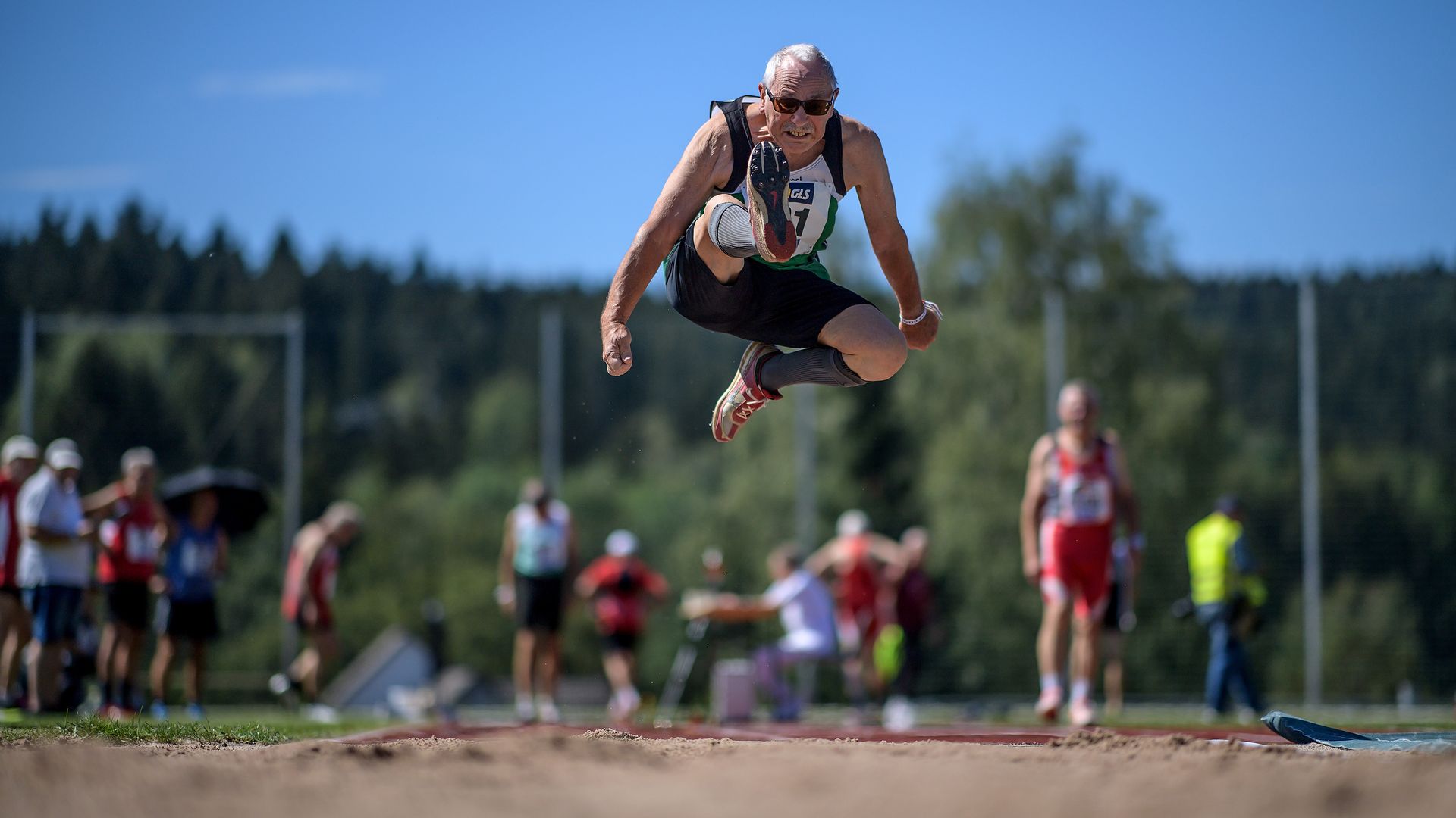 Photo of an older German man competing in the long jump