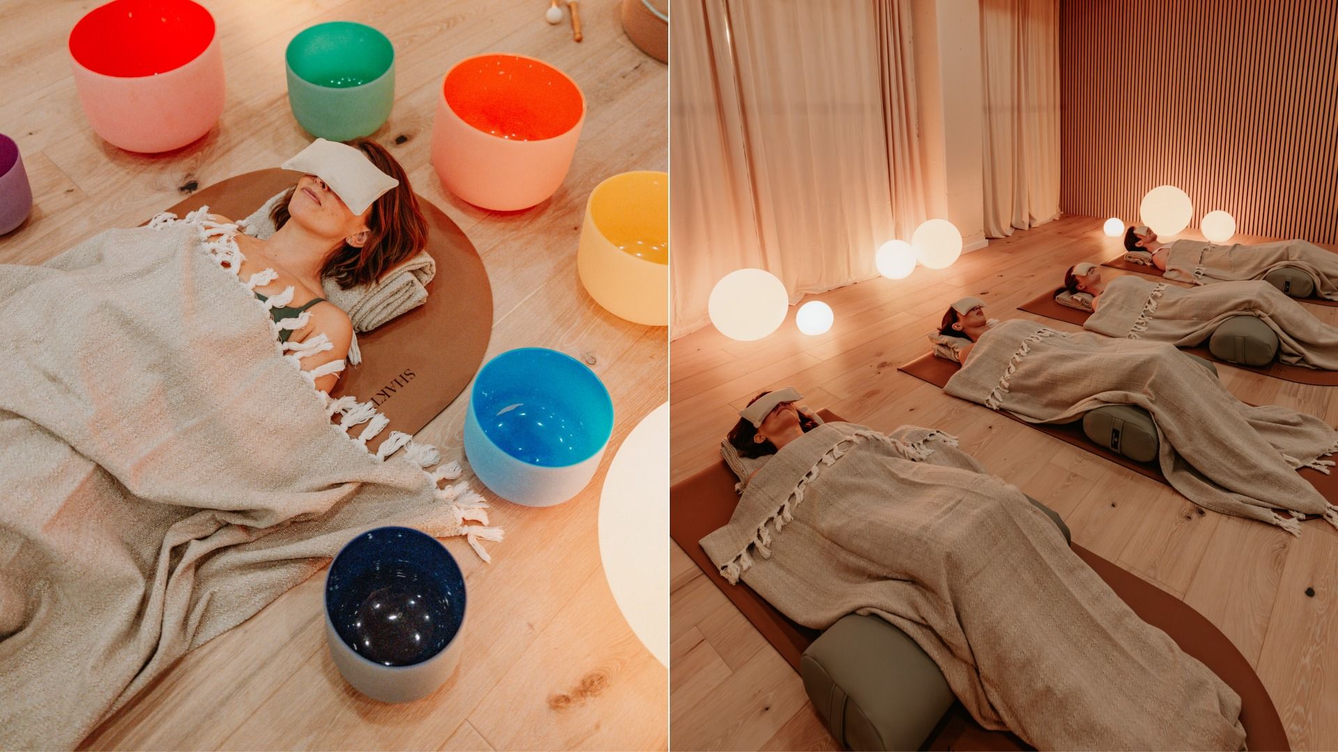 People lying on mats in a calm room, covered with beige blankets and eye masks, surrounded by colorful bowls and soft glowing round lamps for meditation or sound therapy.