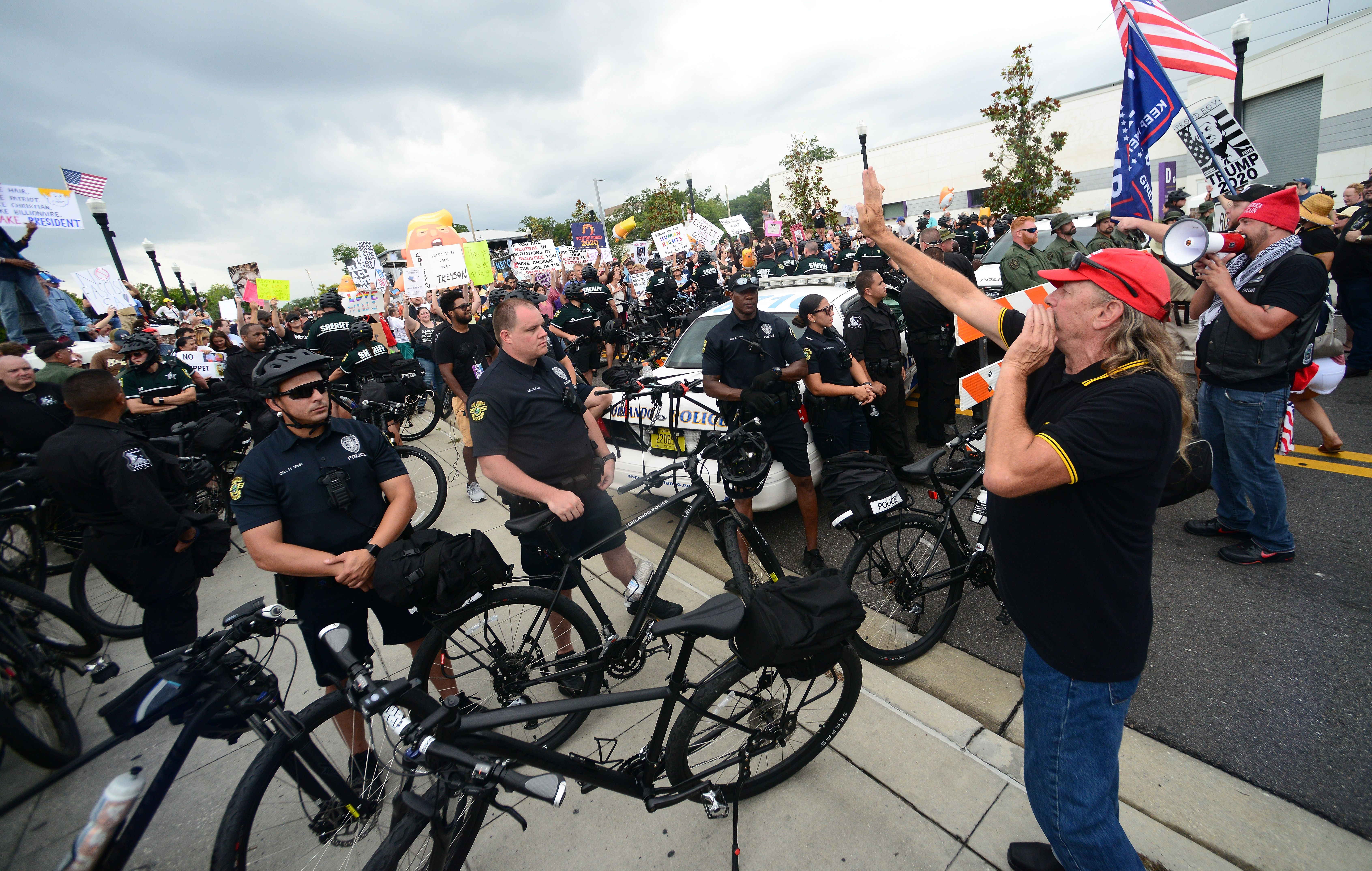 Members of the Proud Boys face off against anti-Trump protesters outside a rally where President Trump officially launched his re-election campaign on June 18, 2019 in Orlando, Florida. 