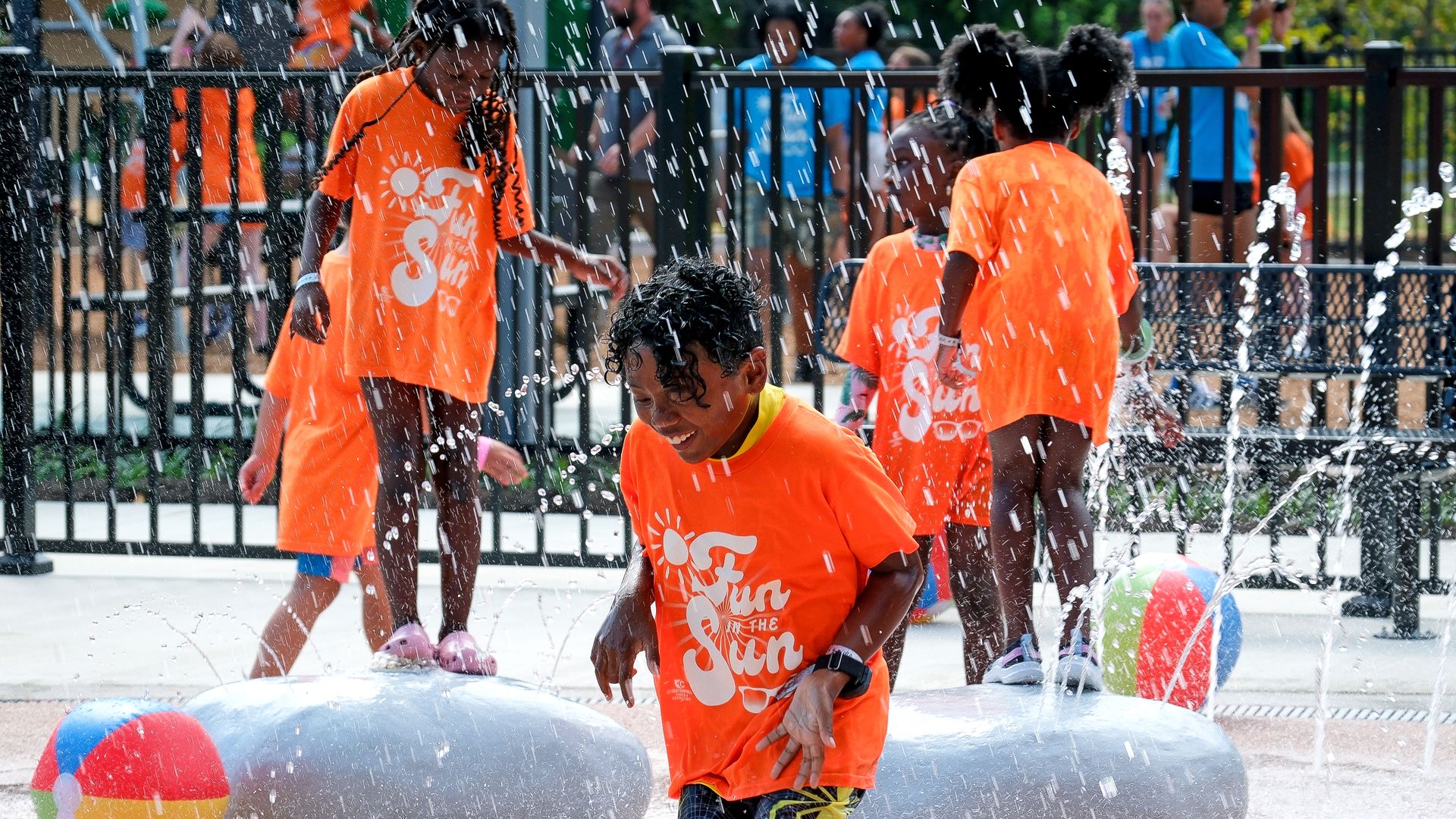 Kids jumping and playing in a spray park 