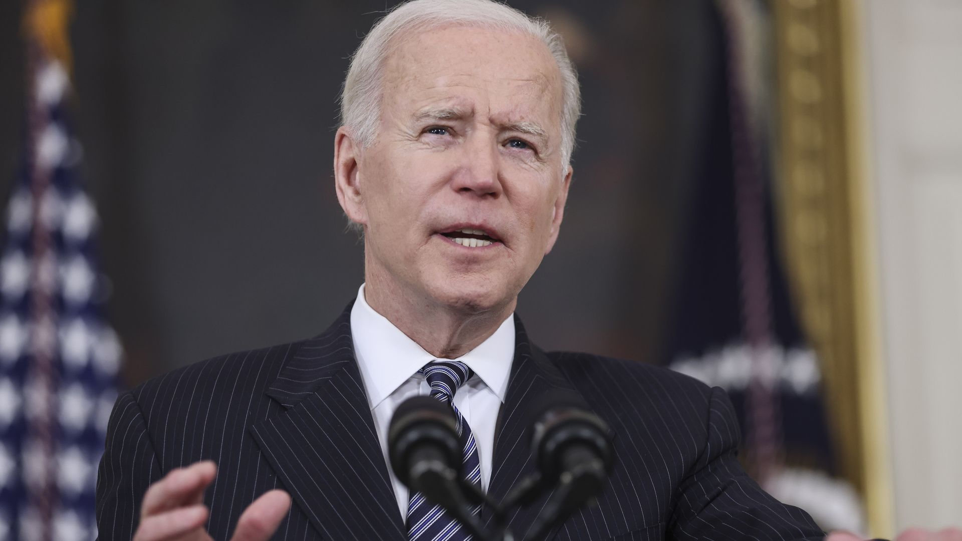 Joe Biden speaks into a microphone