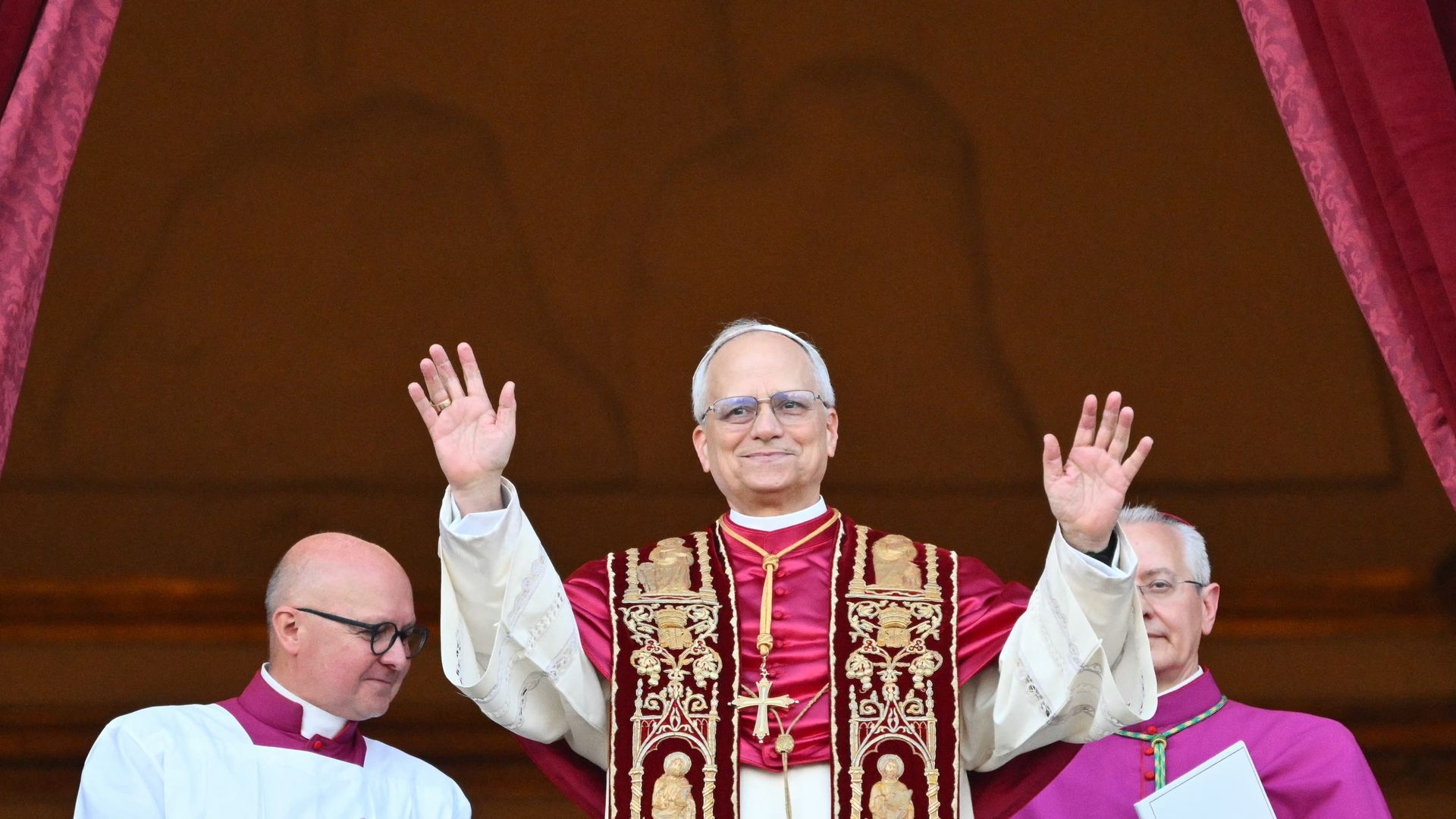 Pope Leo XIV waves to onlookers as he arrives on the main central loggia balcony of the St Peter's Basilica