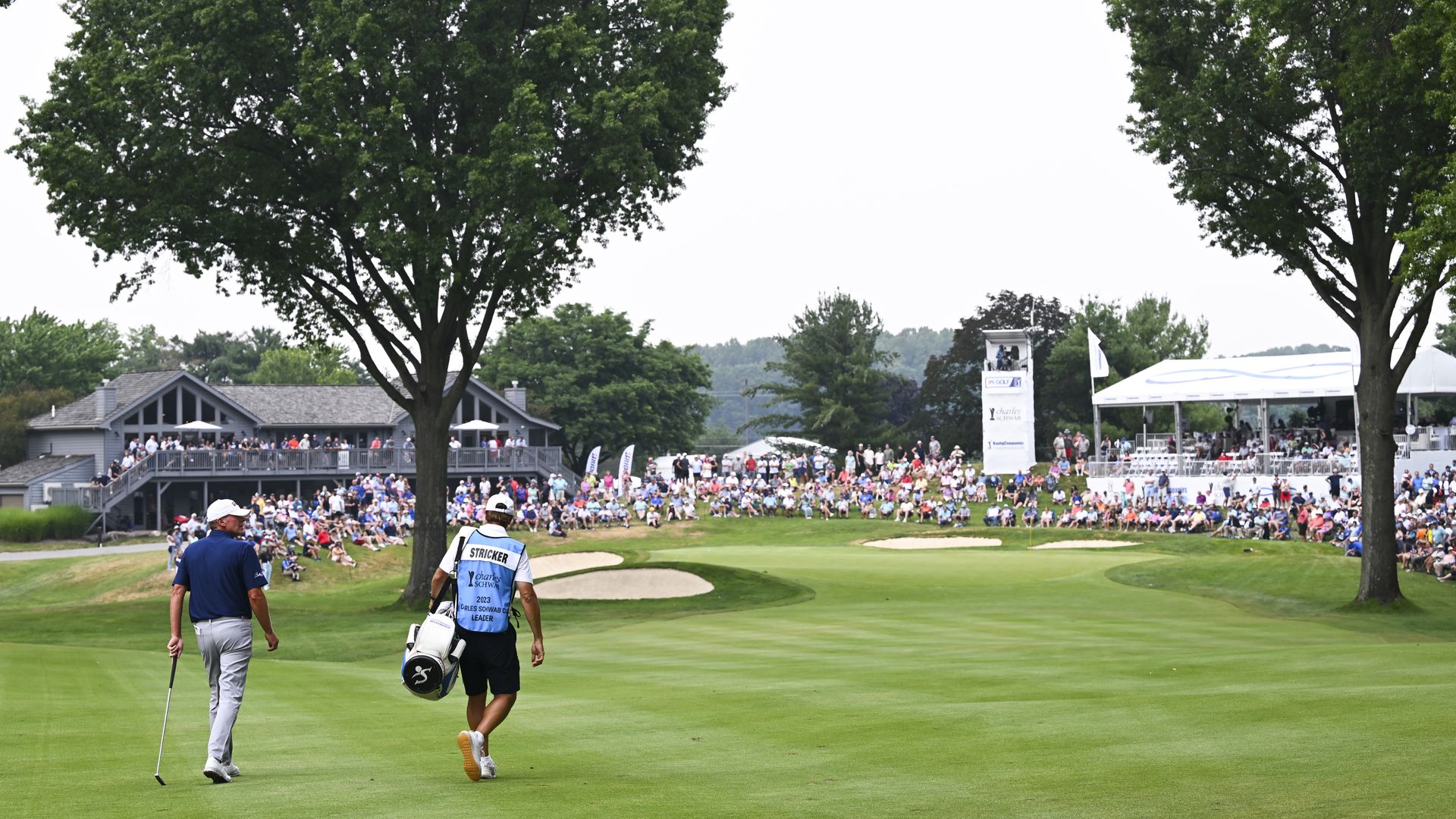 Golfer and caddie approach a green at Firestone South