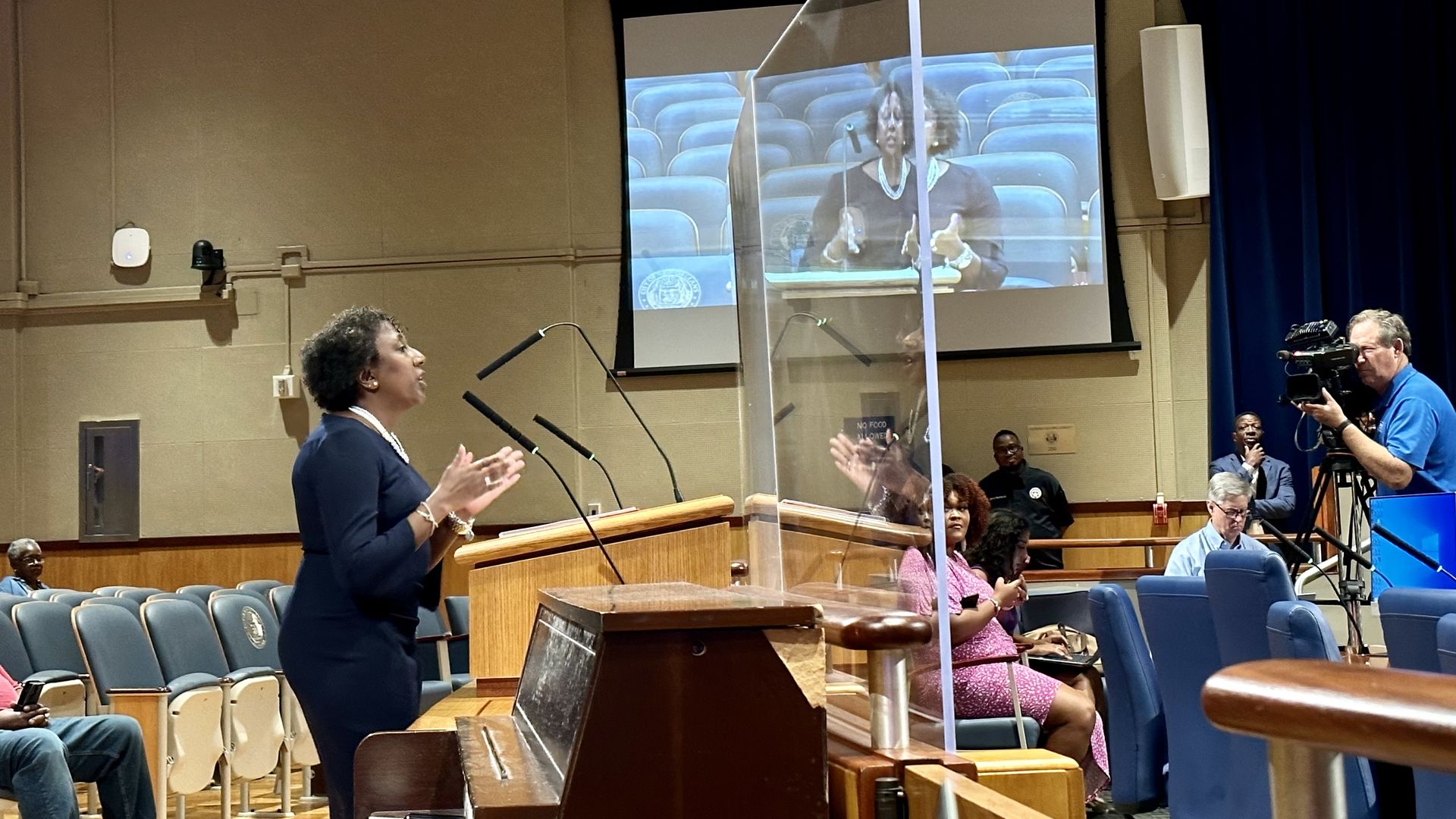 Photo shows the city attorney in front of the city council