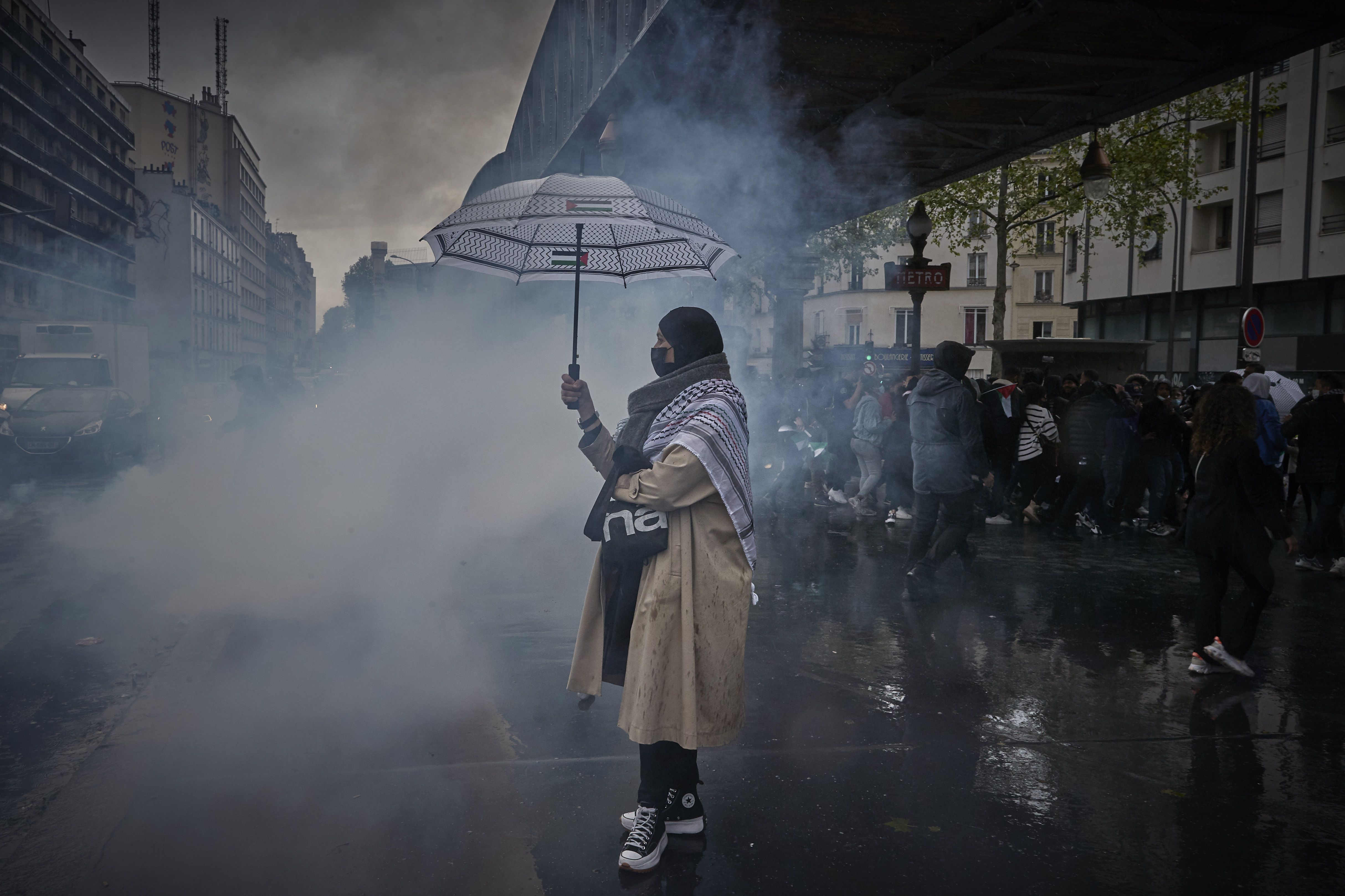 A Pro-Palestine Protestor stands in a cloud of tear gas as a Protest in Solidarity with Palestine turns violent on May 15, 2021 in Paris, France. 