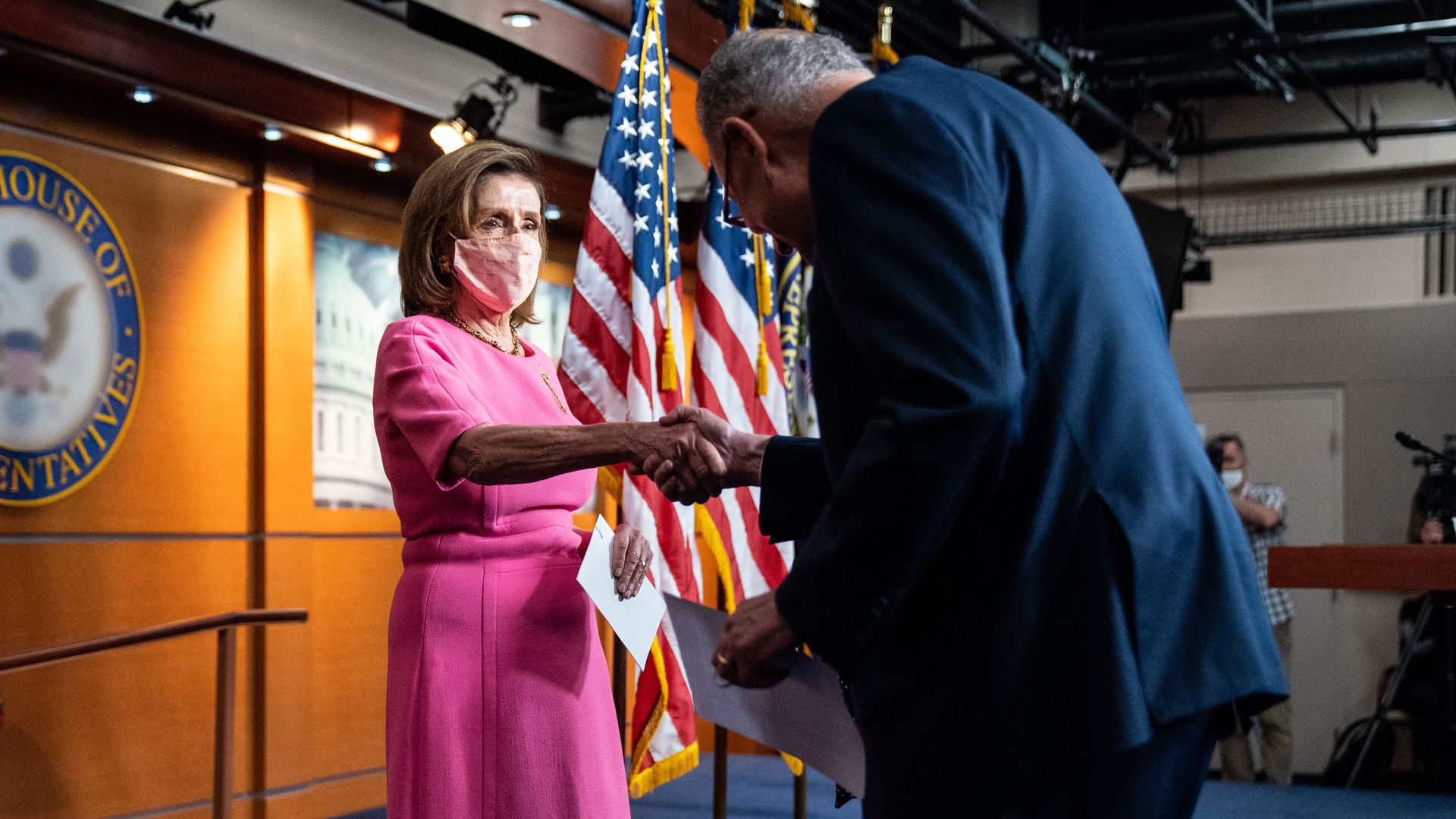 House Speaker Nancy Pelosi (D-Calif.) shaking Senate Majority Leader Chuck Schumer's (D-N.Y.) hand during a press conference in September 2021.