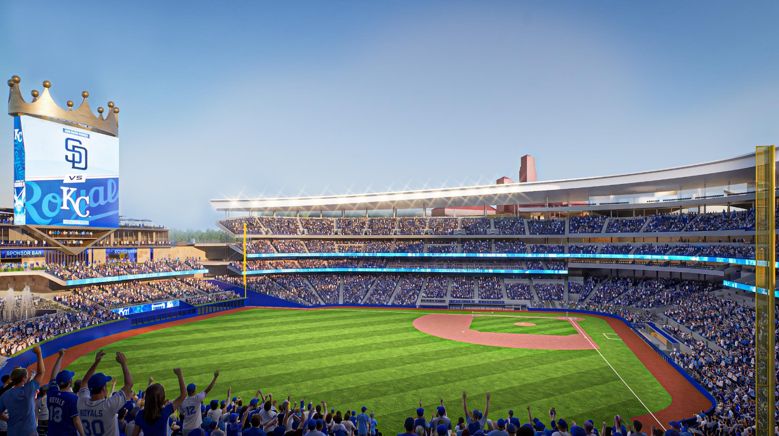 Sunlit baseball stadium packed with blue-clad fans. A tall scoreboard crowned with gold sits at the left, displaying KC/Royals branding. Green outfield, red-brown infield, and cheering crowds throughout.