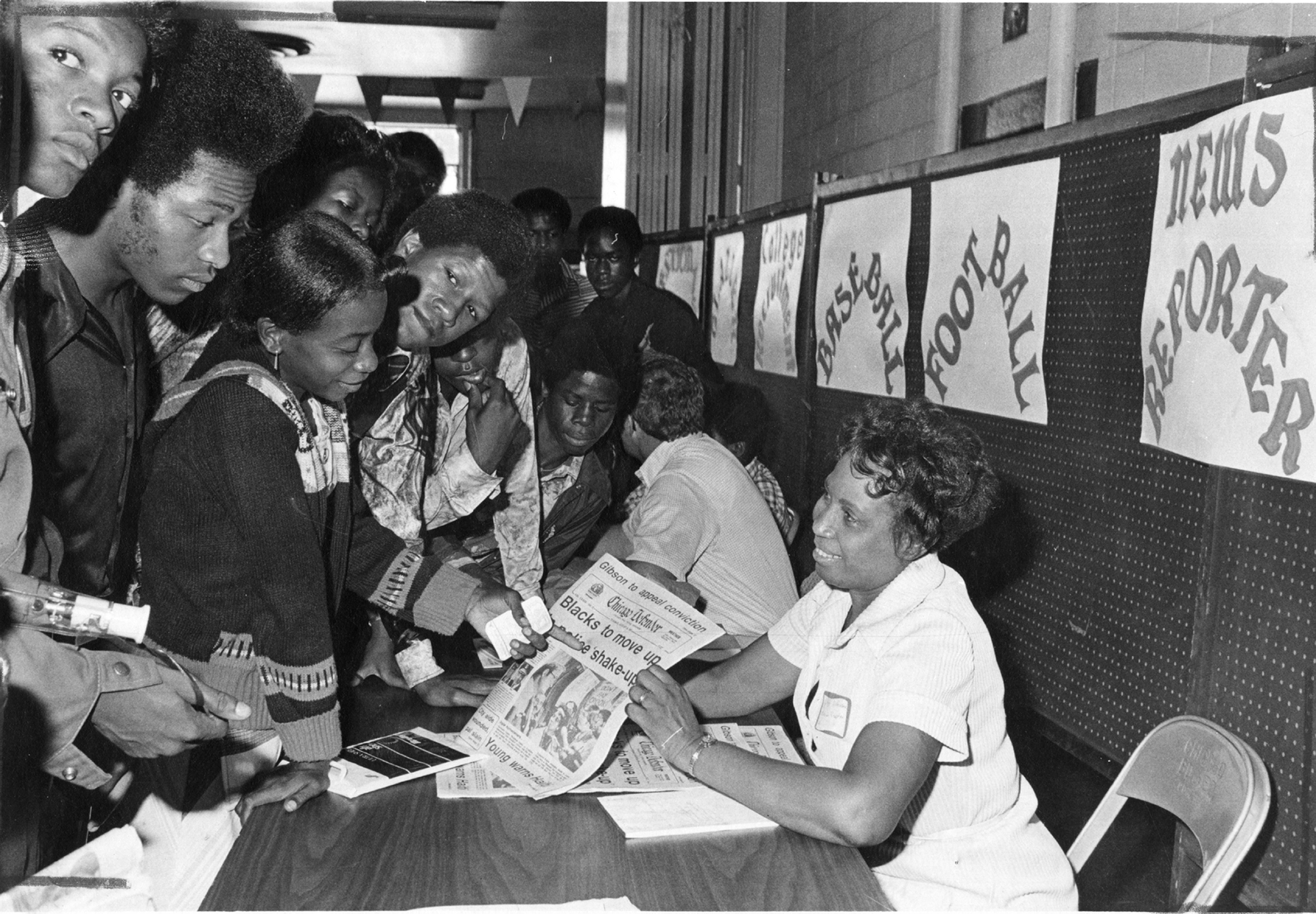 Photo of kids surrounding a table during a job fair 