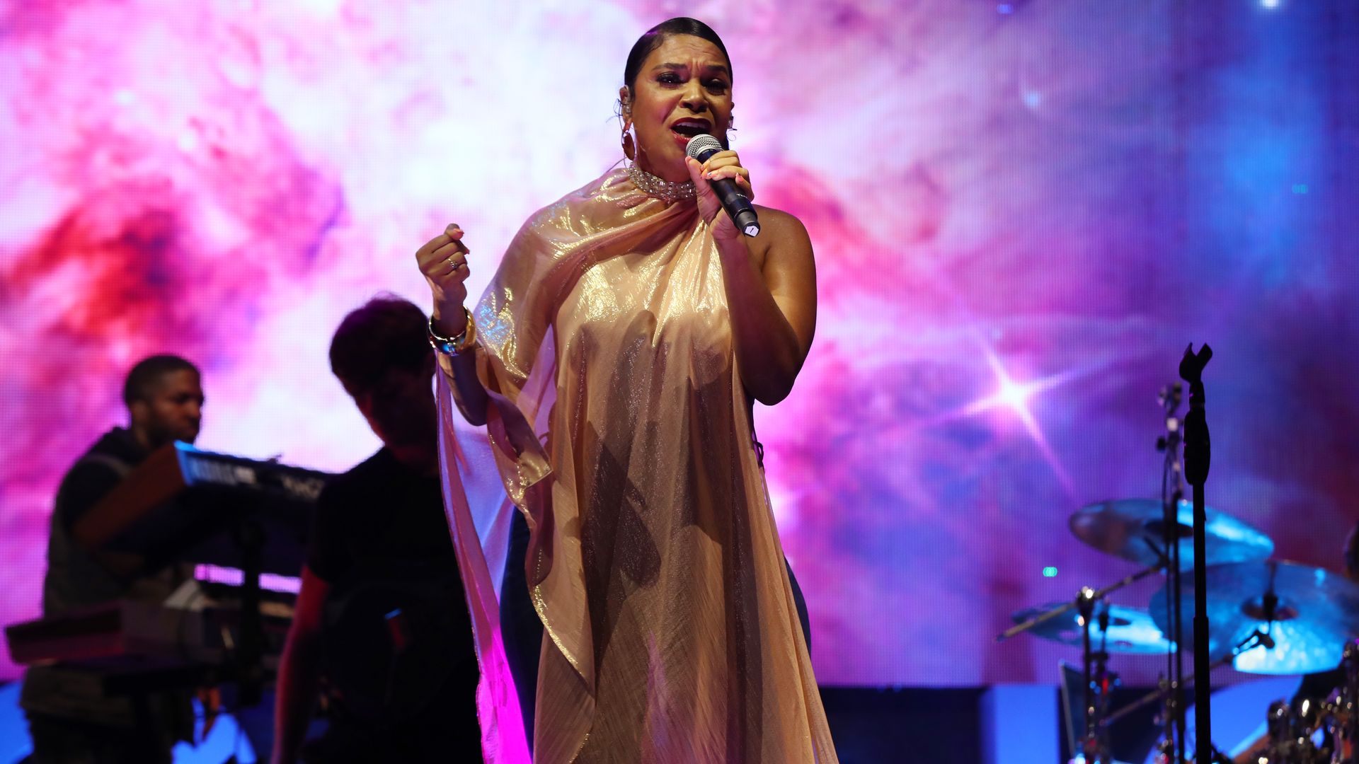 Teedra Moses sings onstage.