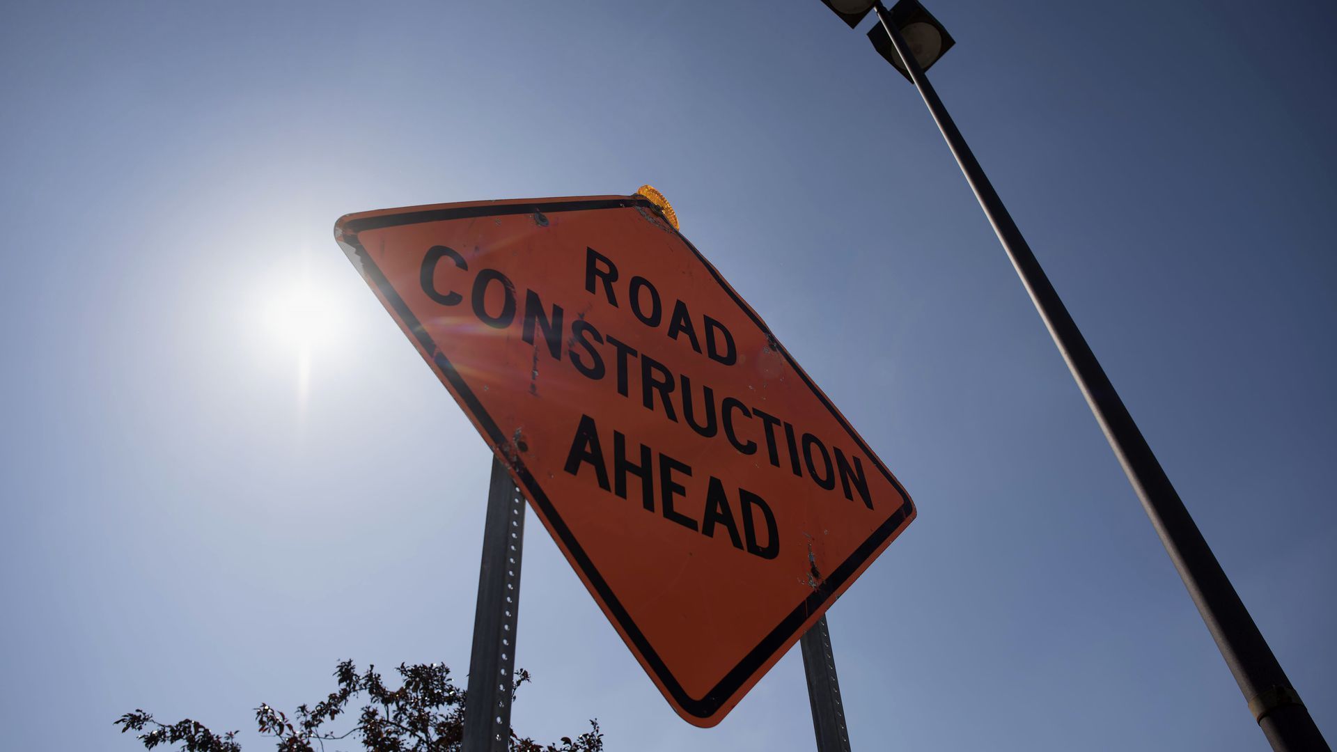 A sign warning of road construction ahead.
