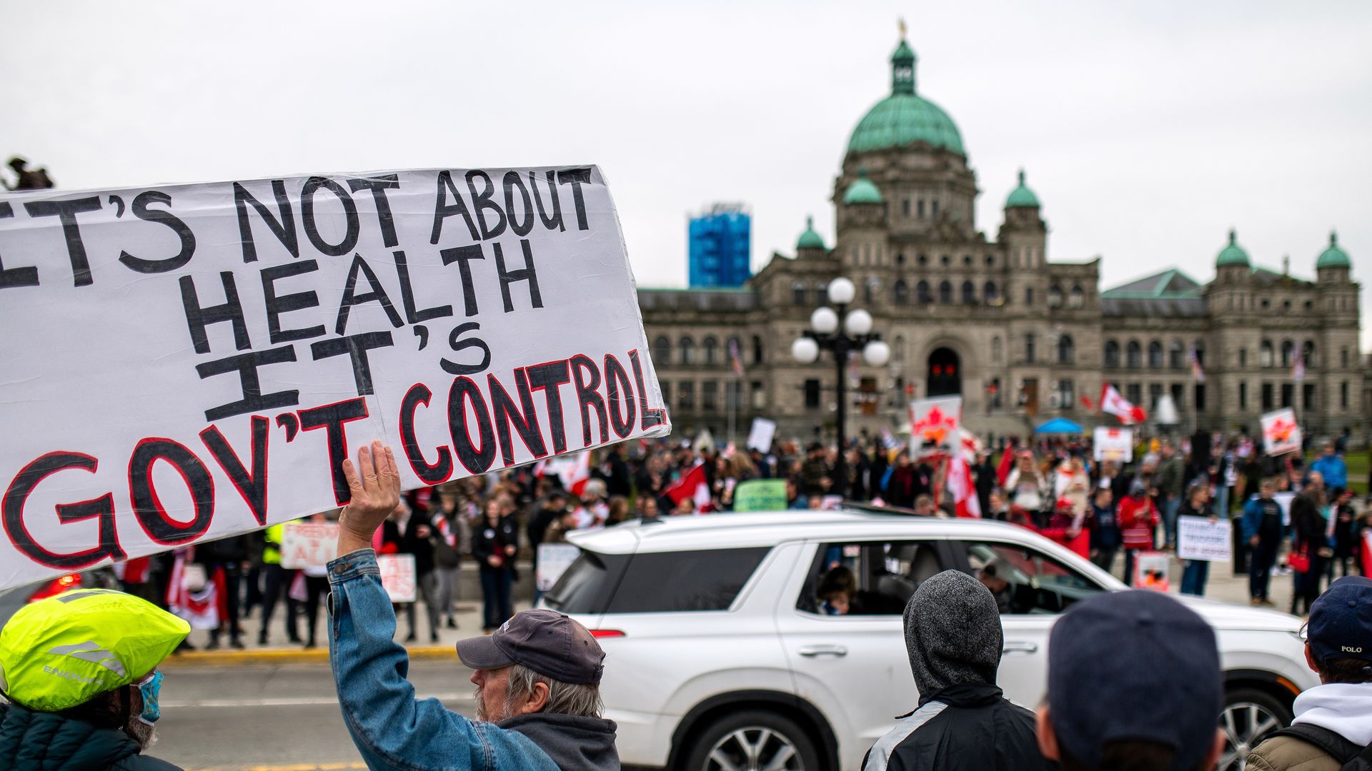 Protesters line the road by the Legislative Assembly of British Columbia during a demonstration in Victoria, British Columbia, Canada, on Saturday, Feb. 5