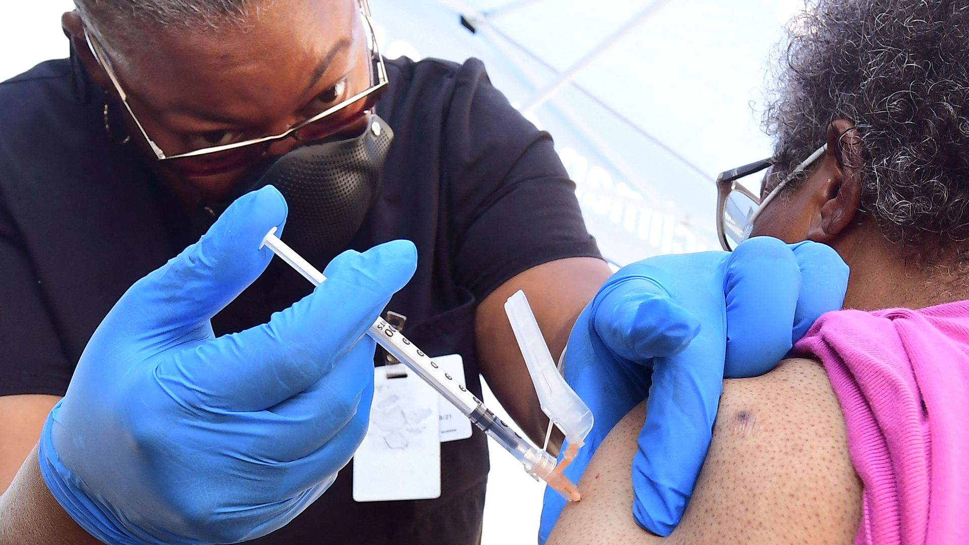 Nurse administers a COVID-19 dose