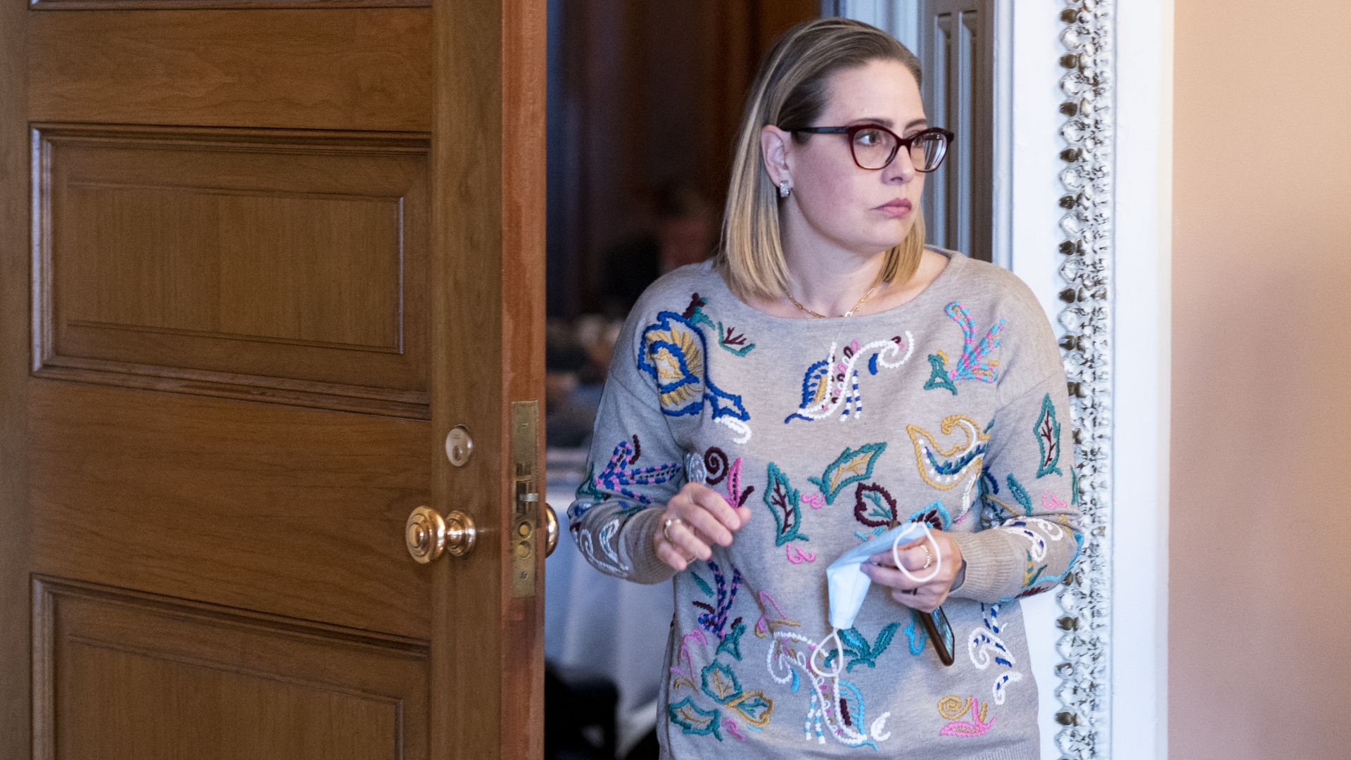 Sen. Kyrsten Sinema is seen leaving the Democratic Policy Luncheon on Tuesday.