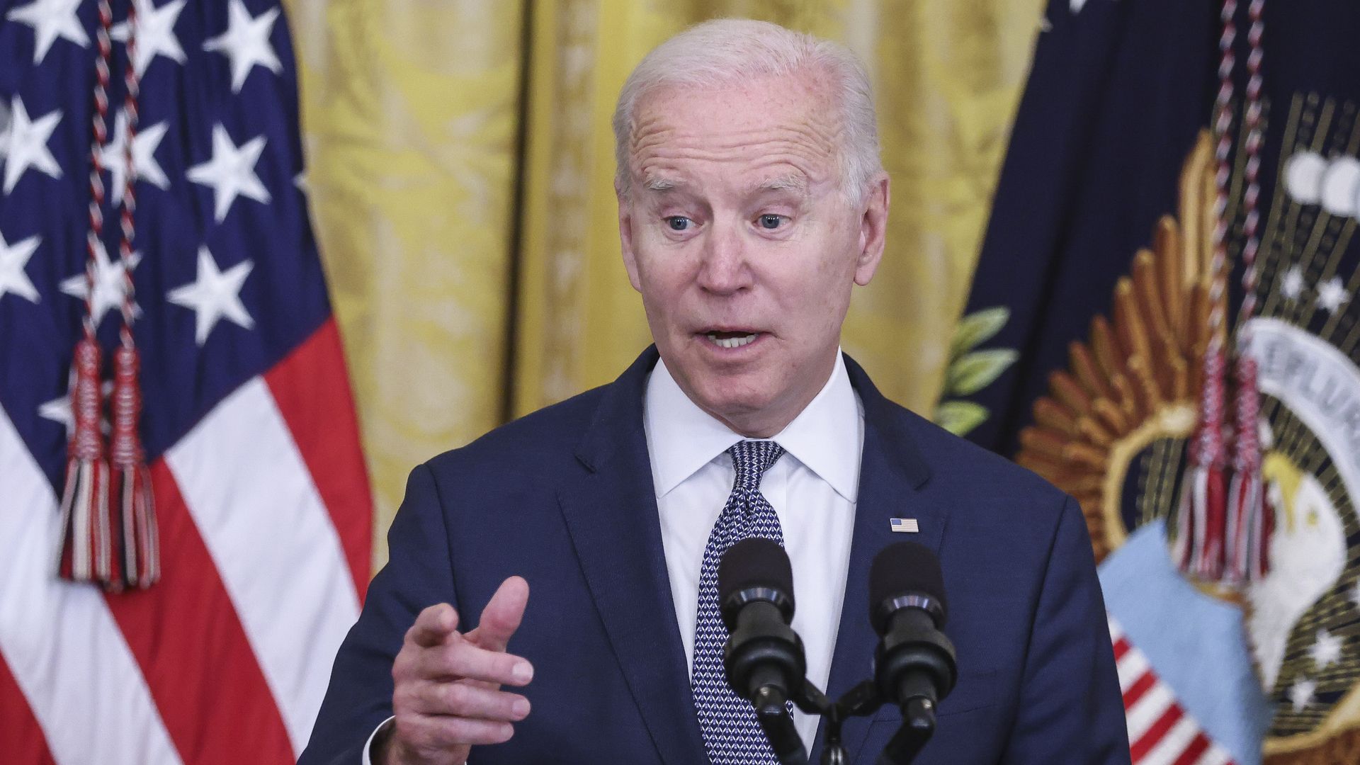 President Biden speaks at a podium.