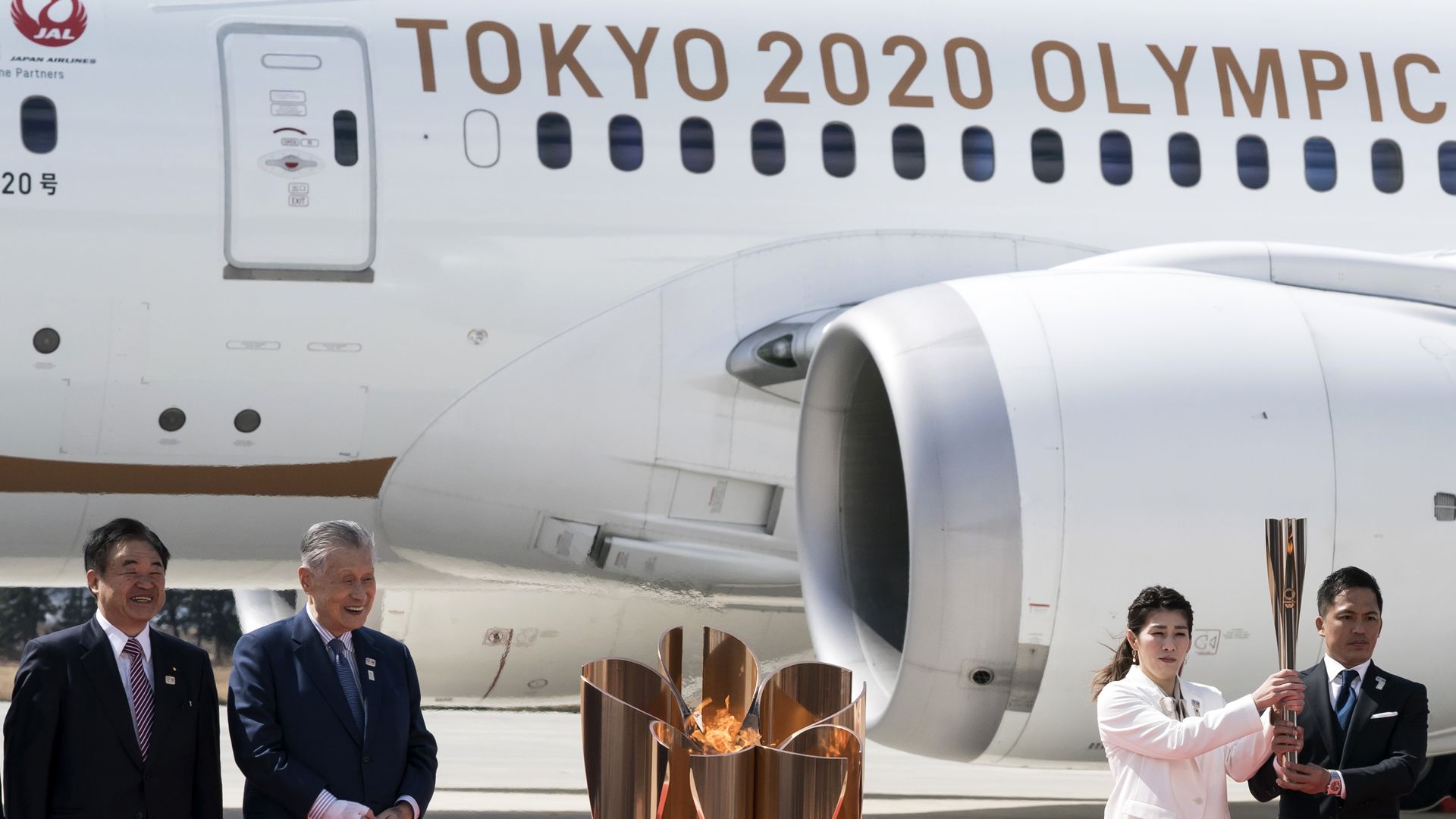 In this image, "Tokyo 2020 Olympics" is written on the side of a plane.