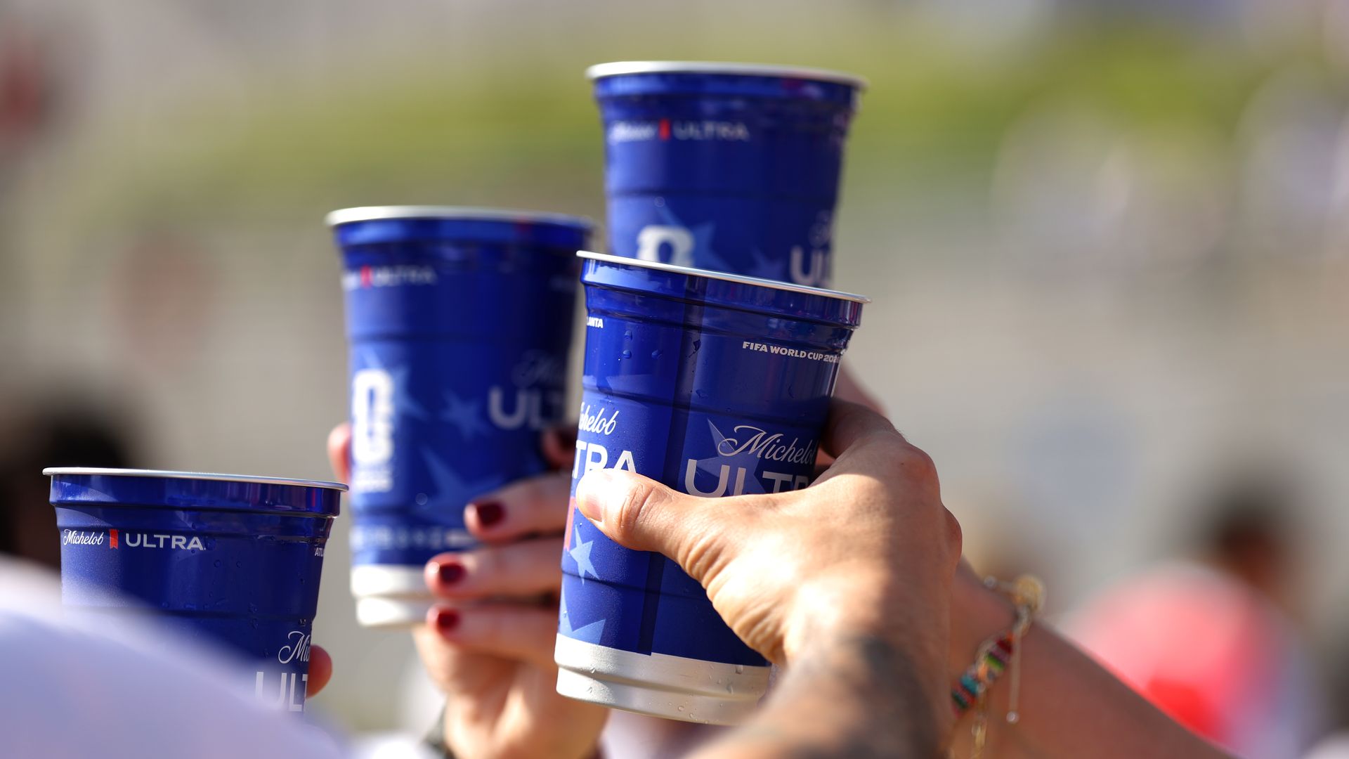 Fans hold cups of beer outside Atlanta Stadium before the FIFA World Cup Round of 32 match between England and DR Congo in Atlanta.
