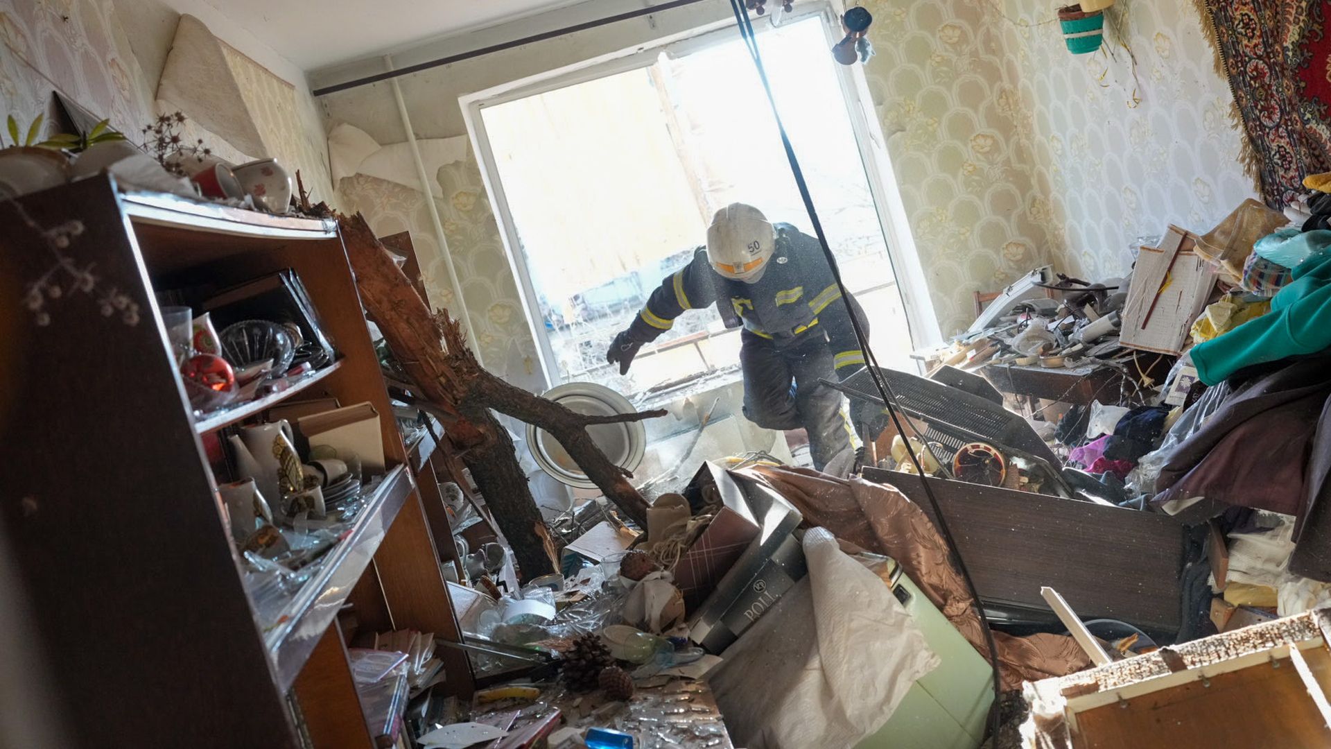 Ukrainian firefighters arrive to rescue civilians after an airstrike hit an apartment complex in Chuhuiv, Kharkiv Oblast, Ukraine on February 24